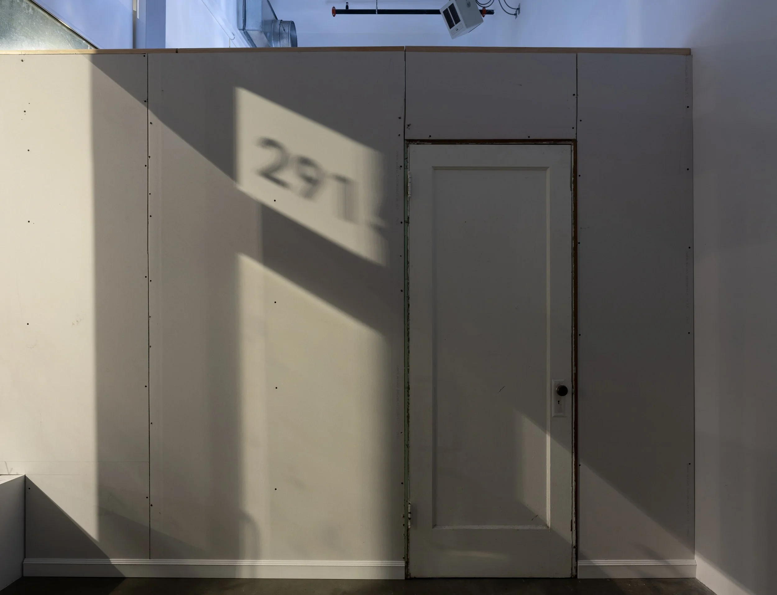 unfinished drywall with a door in the gallery