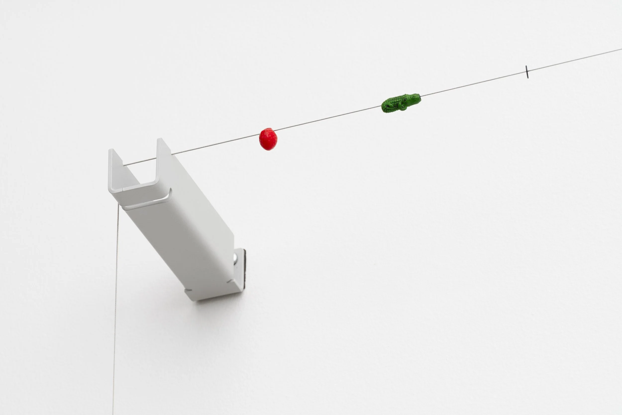 a wire with small beads held tight on a metal bracket