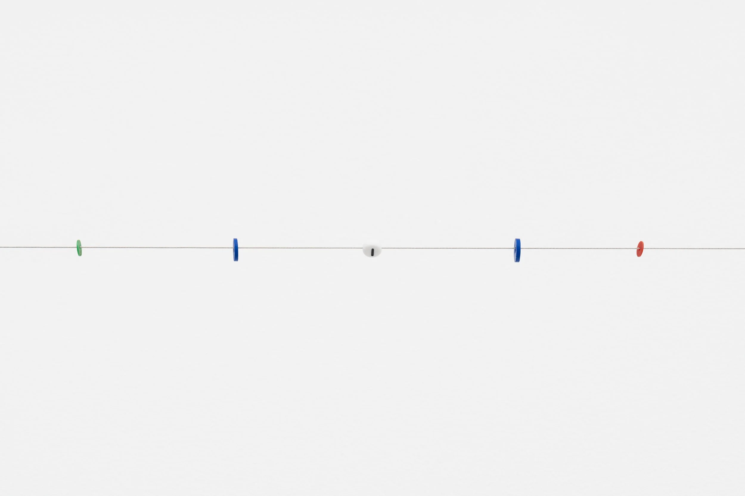 small beads on a wire; one of them reads letter I