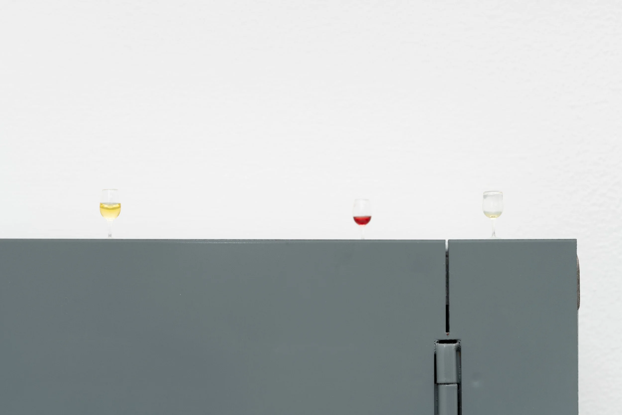 tiny wine glasses with leftover red and white wine