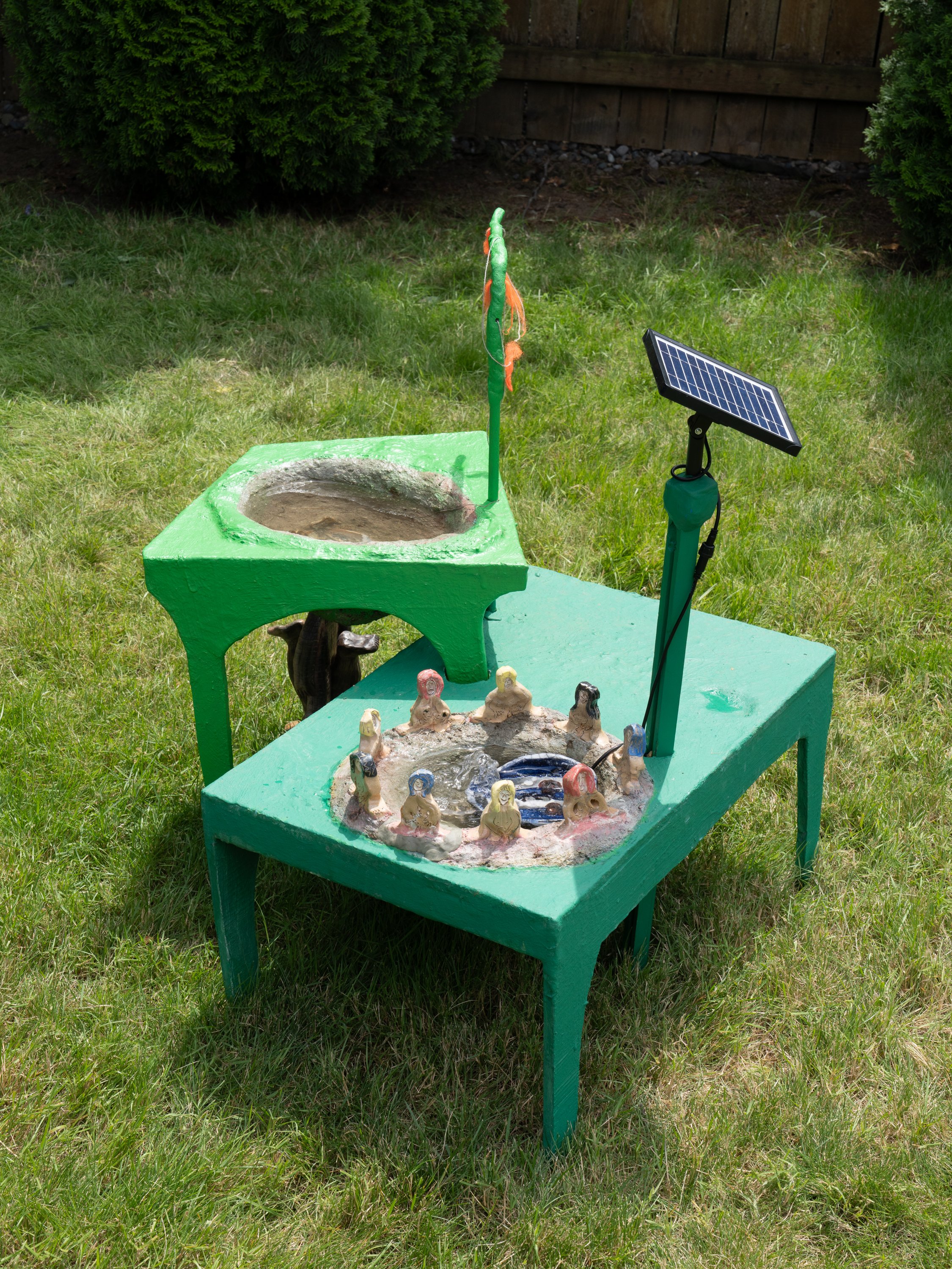 A green sculpture on a lawn.
