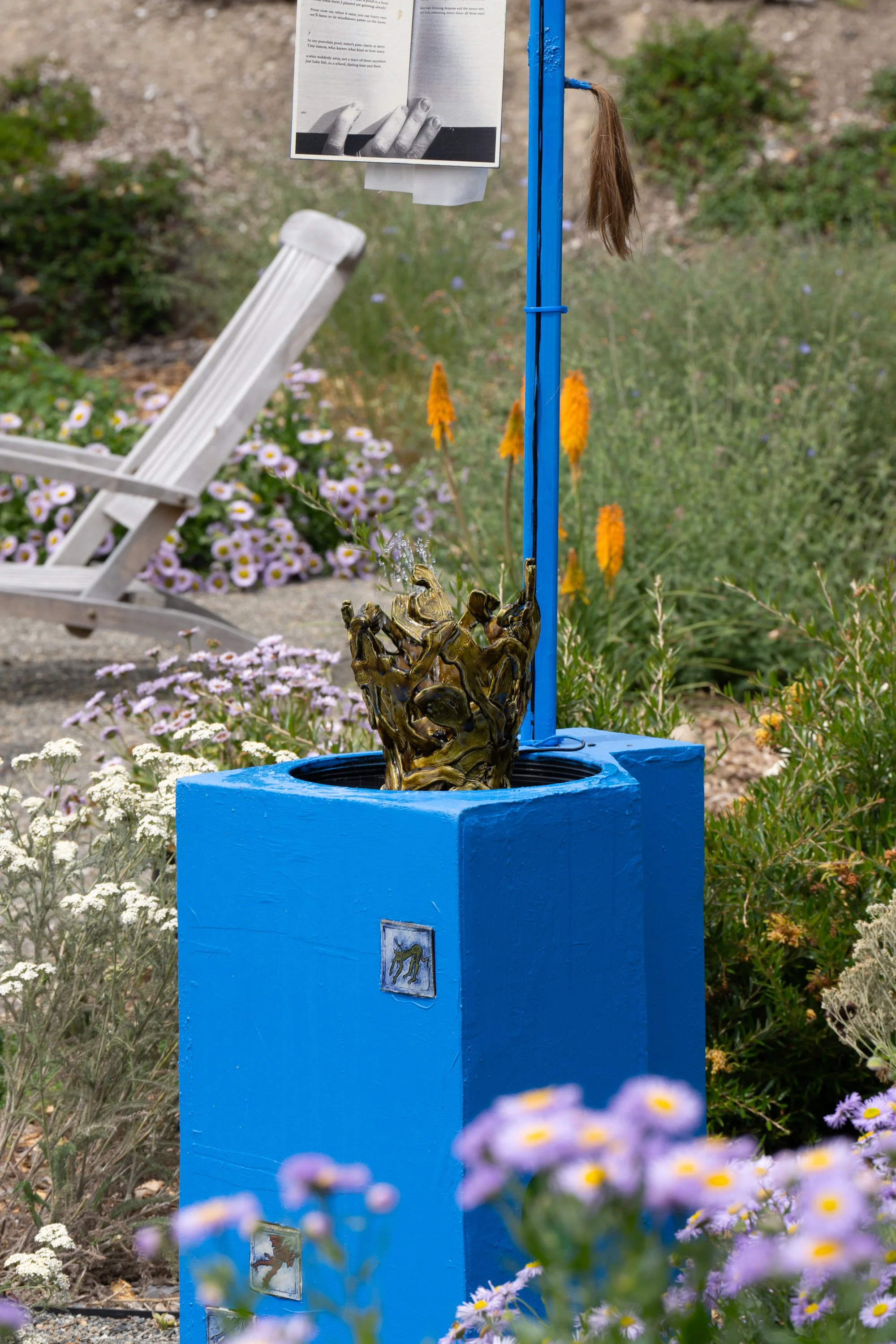 A ceramic vase in a blue sculpture.