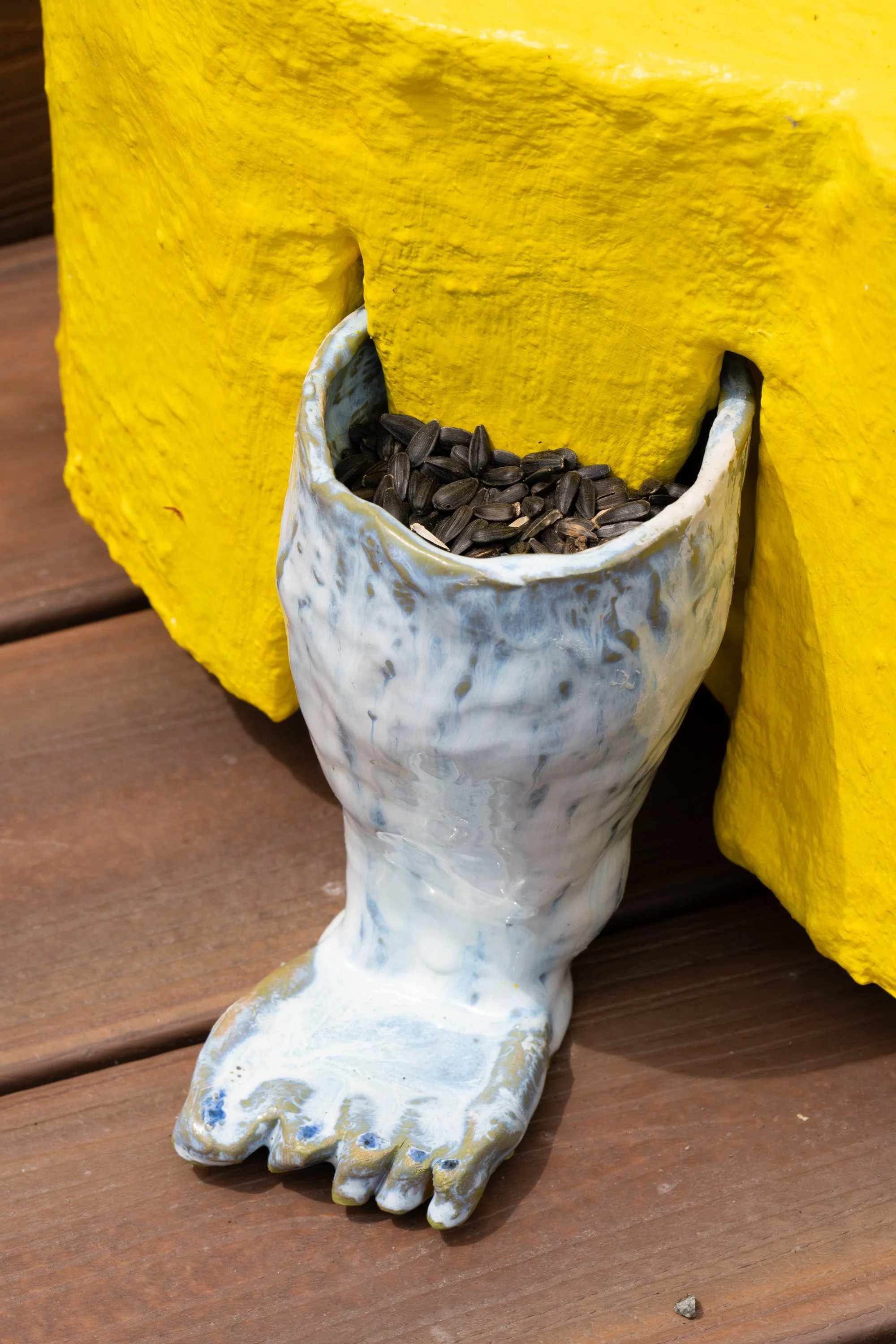 Sunflower seeds in a ceramic leg.