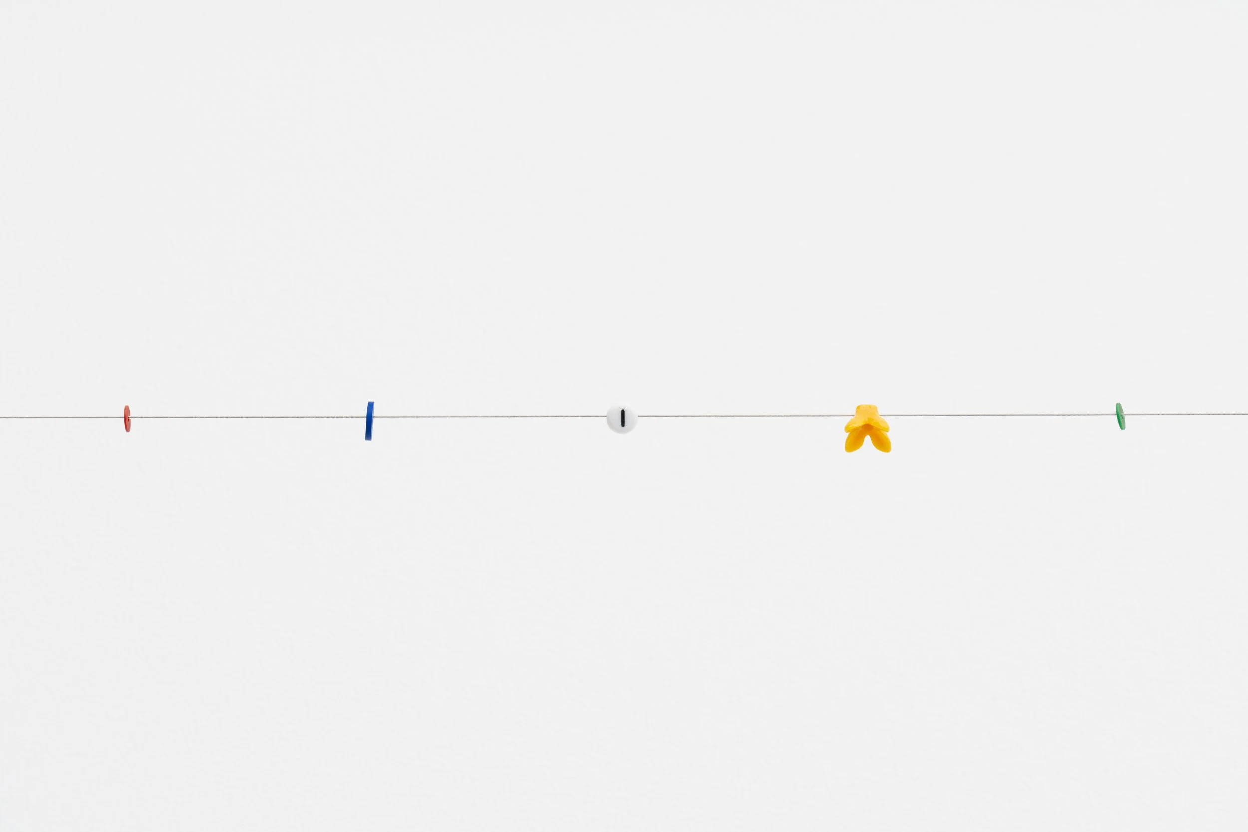 small beads on a wire; one of them reads letter I