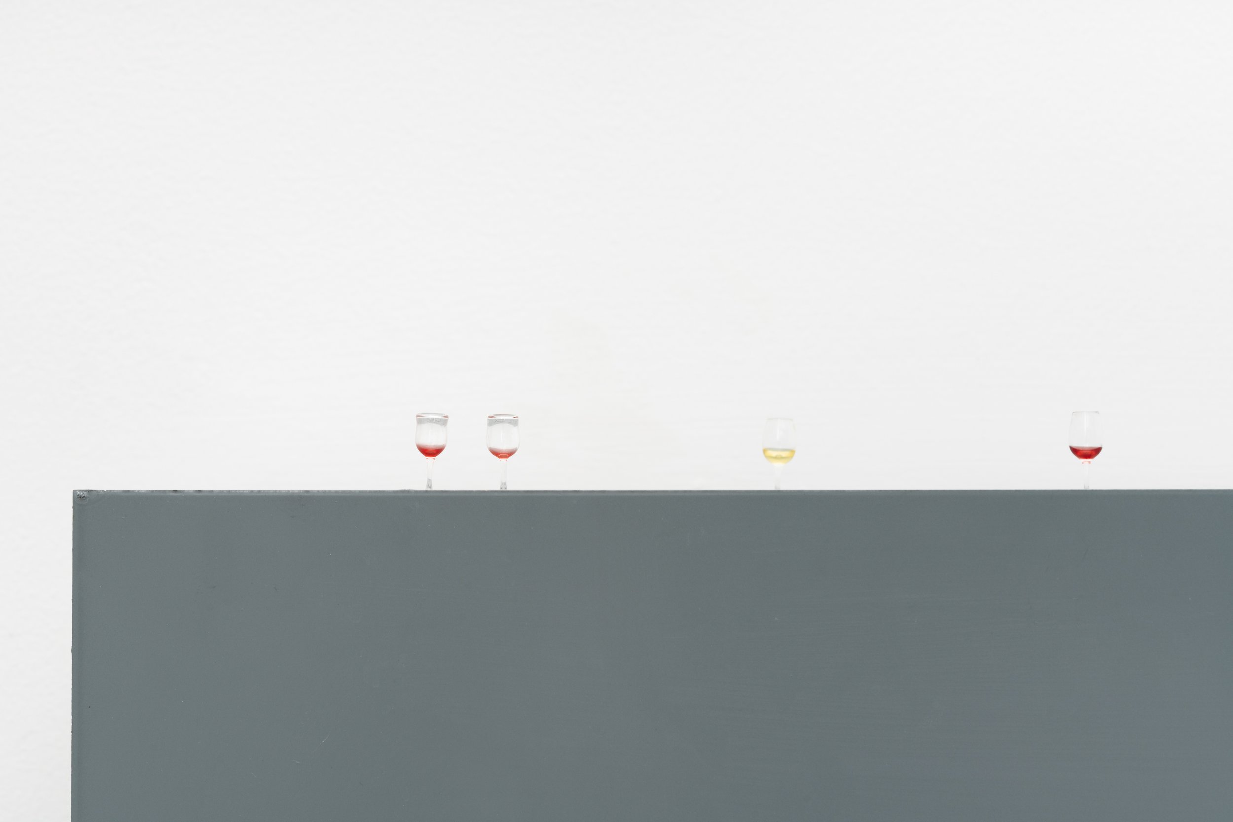 tiny wine glasses with leftover red and white wine
