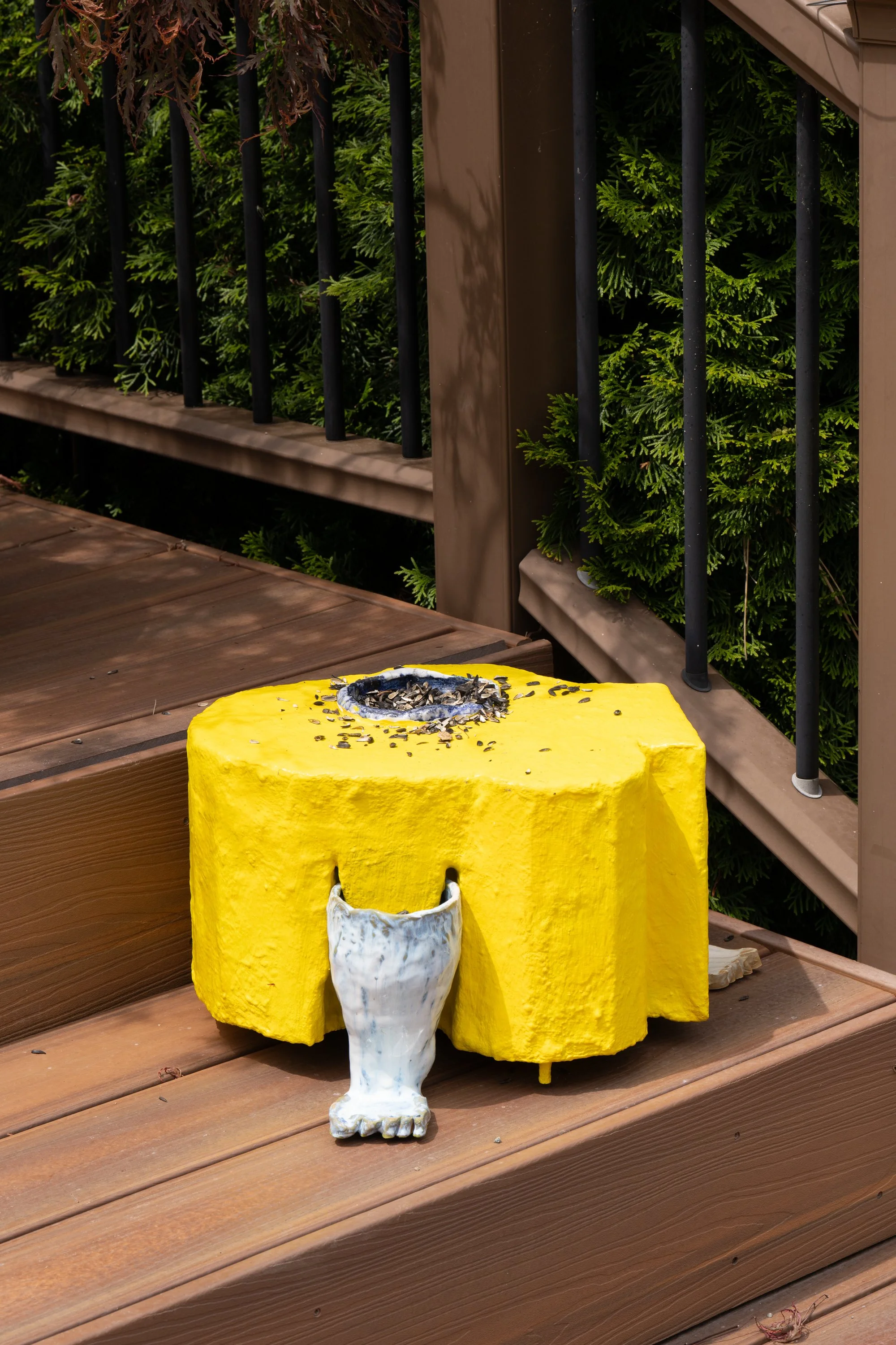 A yellow sculpture with sunflower seeds.