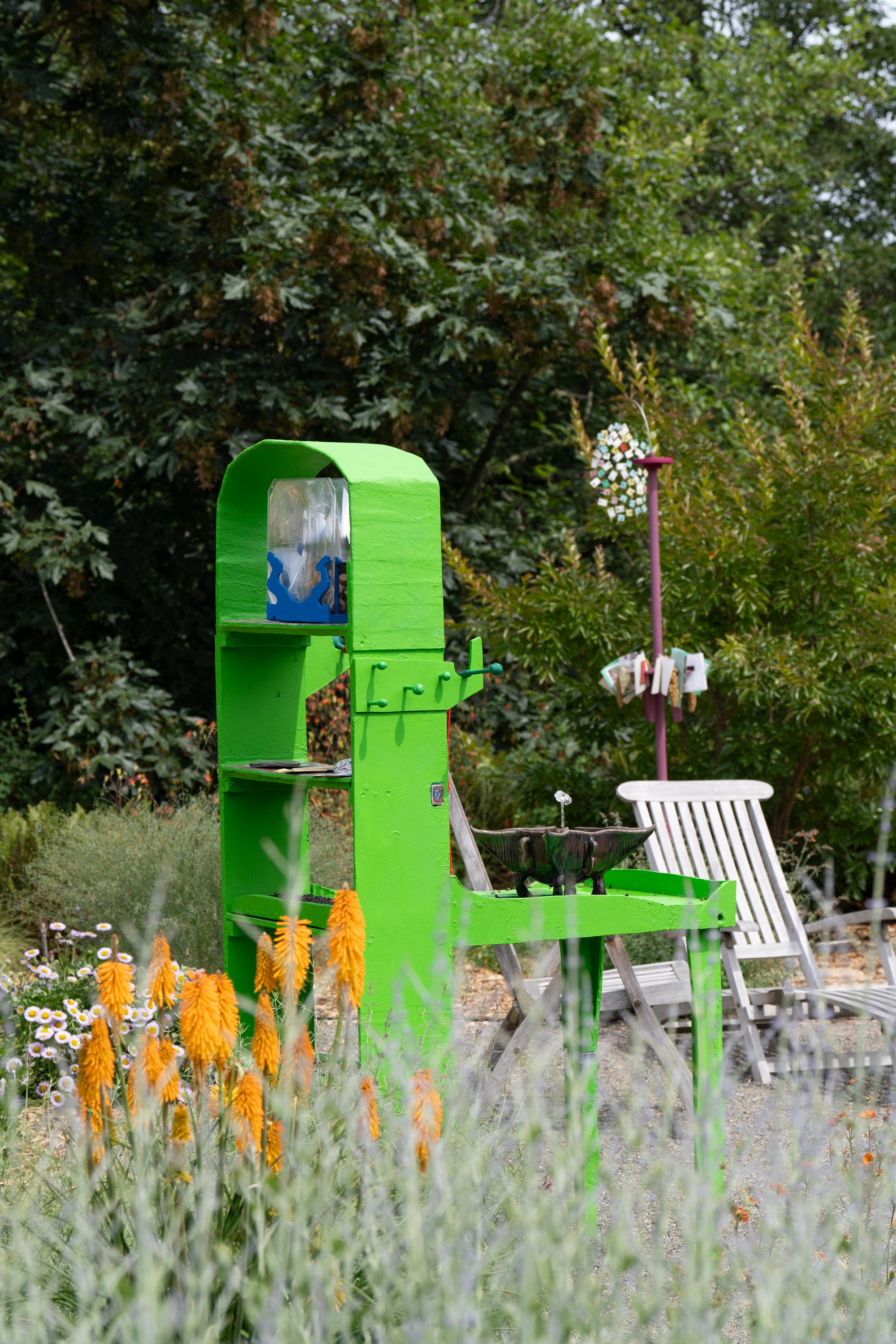 A green sculpture in a garden.