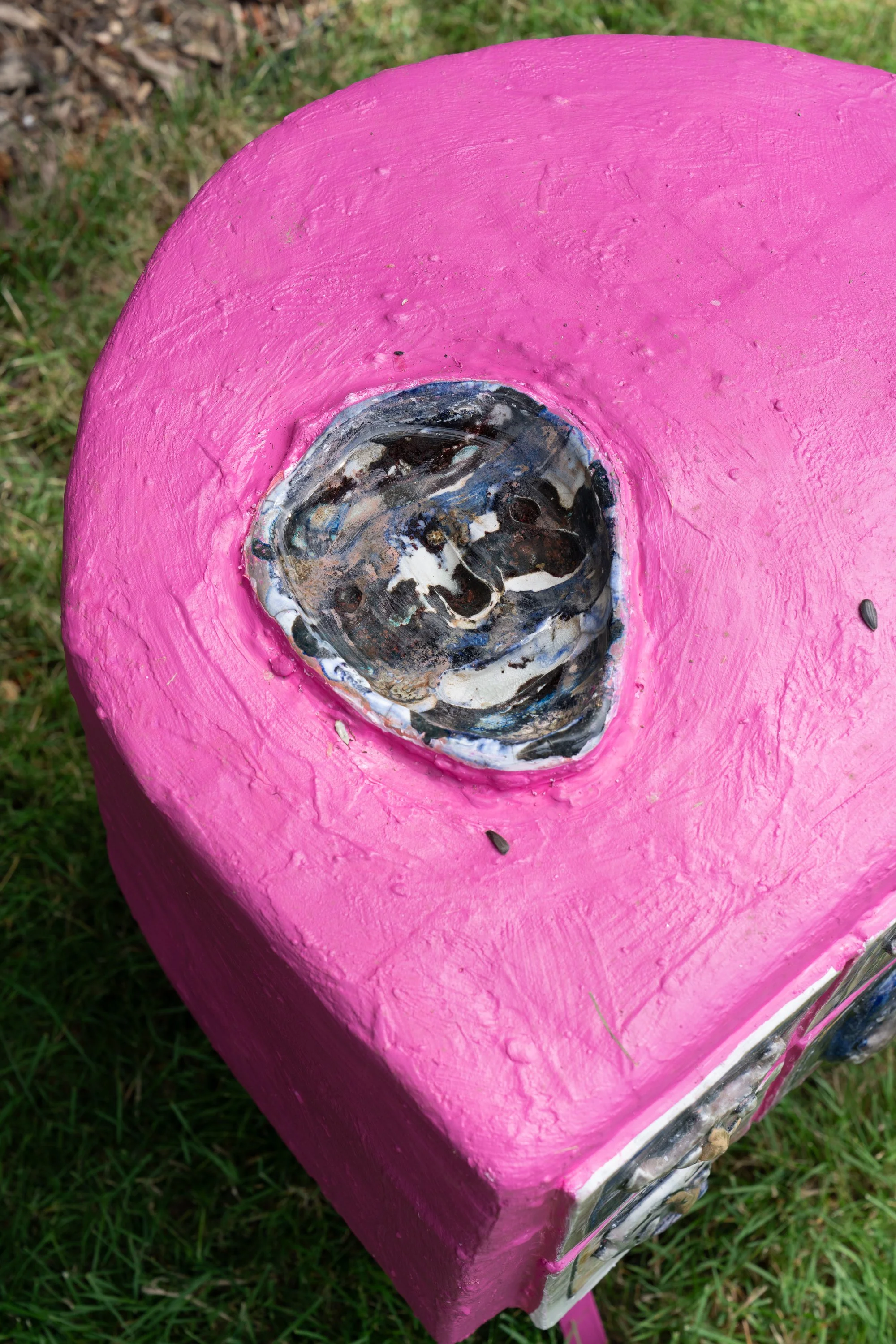 A ceramic tray on a pink sculpture.