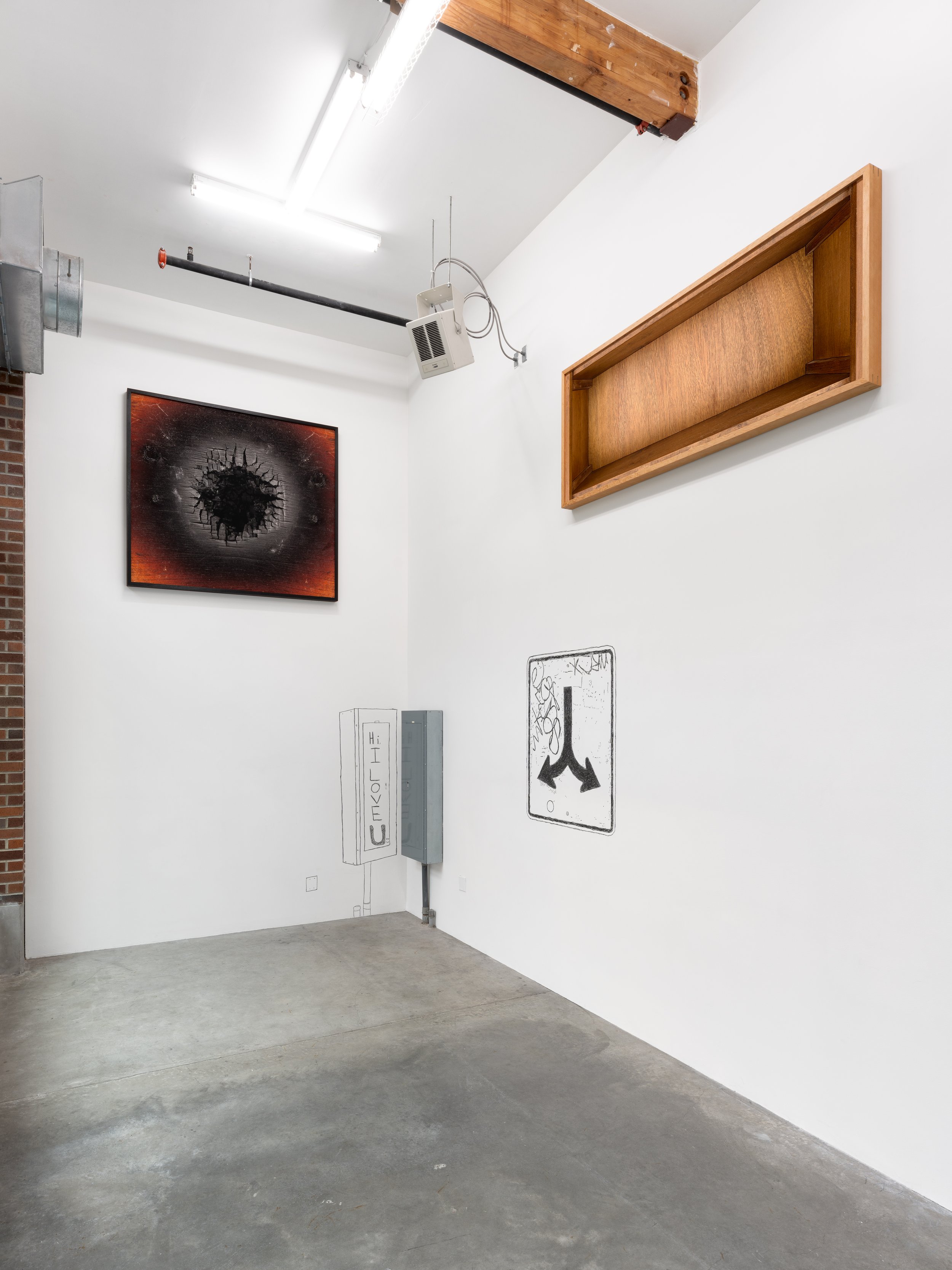 Installation view of 2 photographs and 2 charcoal drawings.
