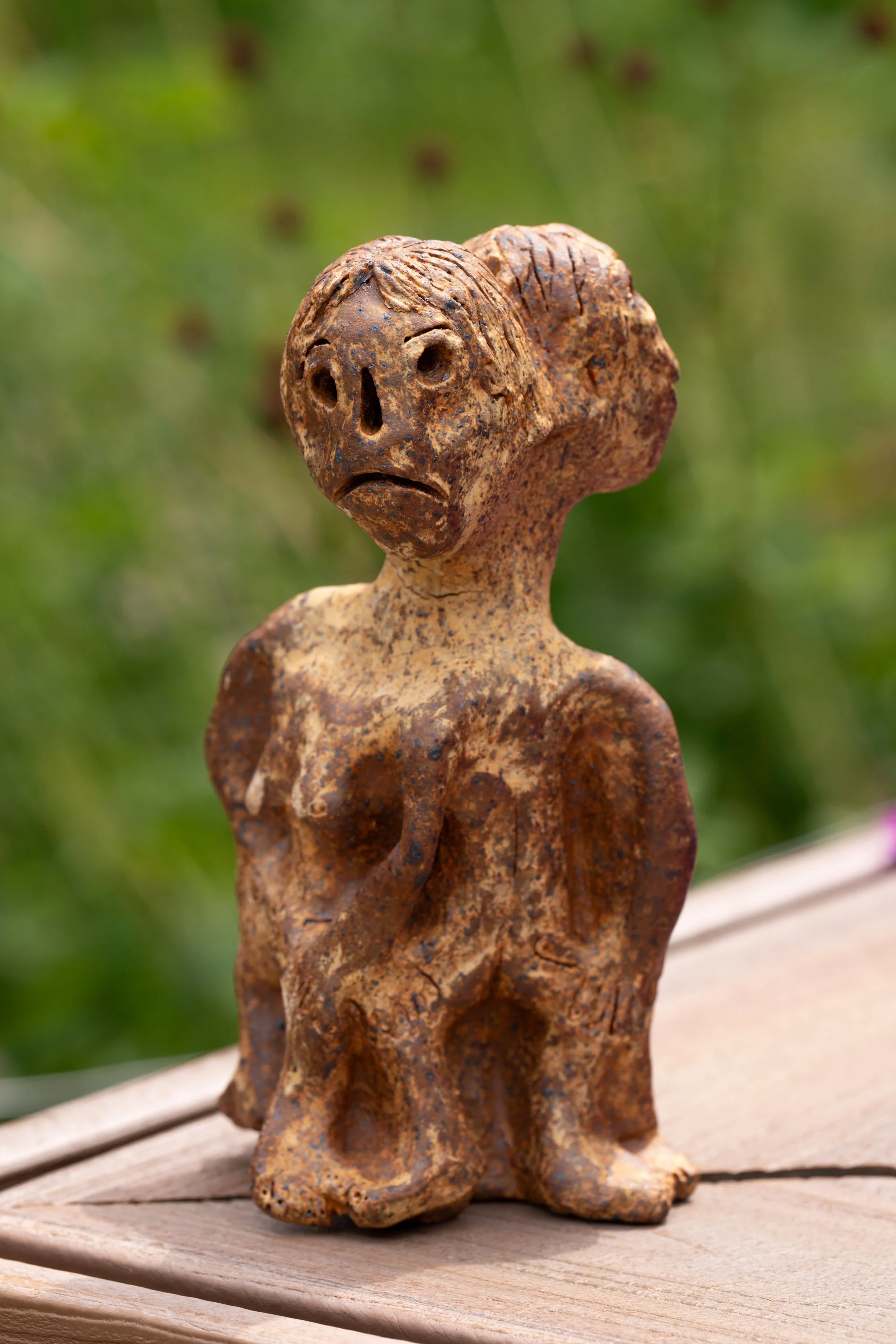 A ceramic figure with two heads.