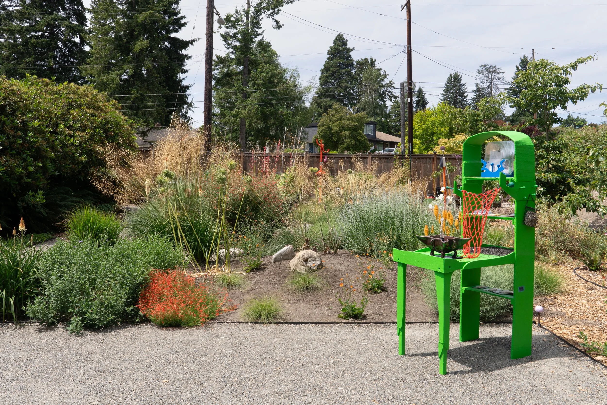 A green sculpture in a garden.