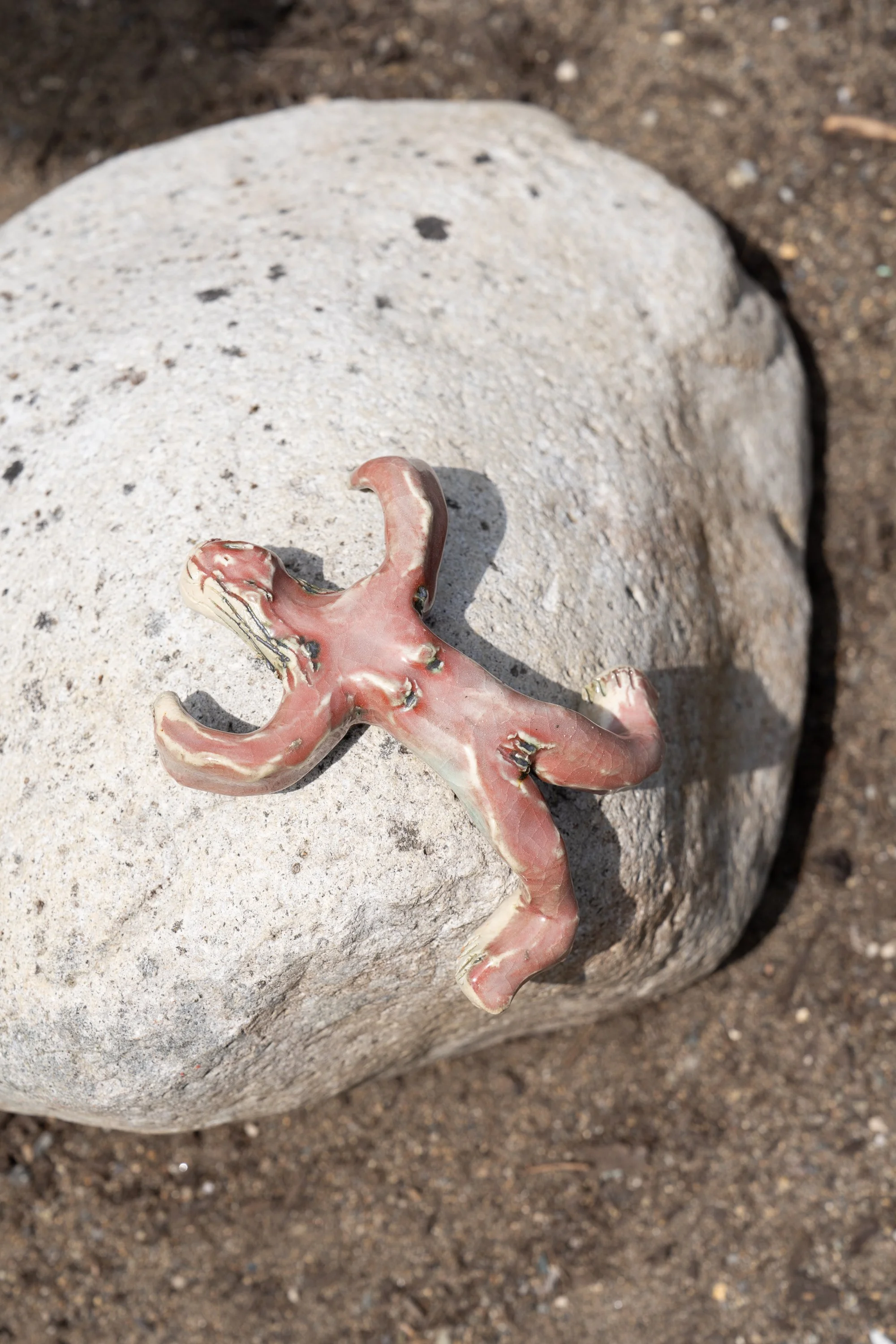 A ceramic figure on a rock.