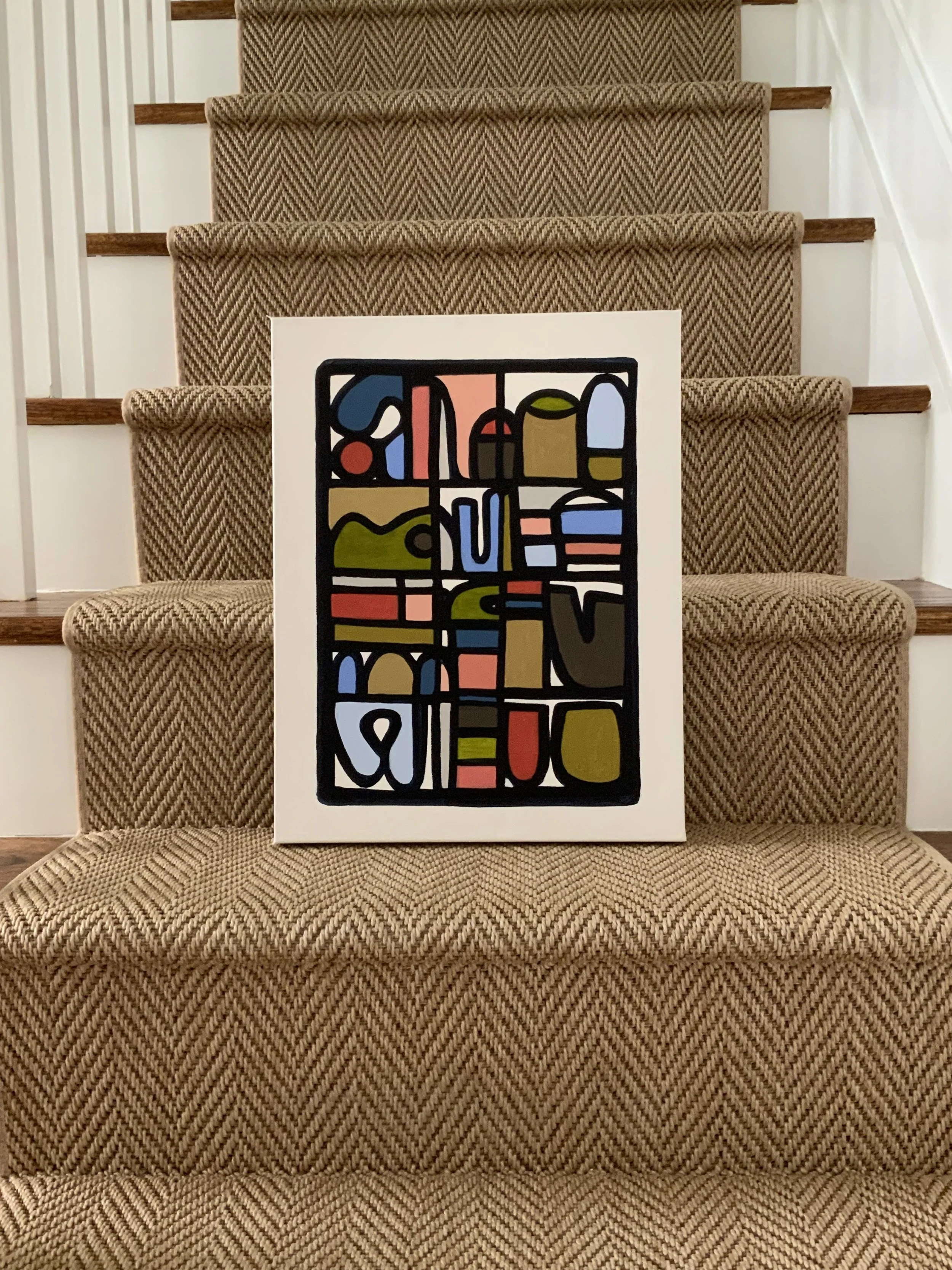 A painting with abstract shapes and a variety of colors, including blue, green, red, pink, yellow, brown, black, and white, leaning against a staircase with carpeted stairs and white walls. Denise Mortensen is a New Jersey abstract artist known for S