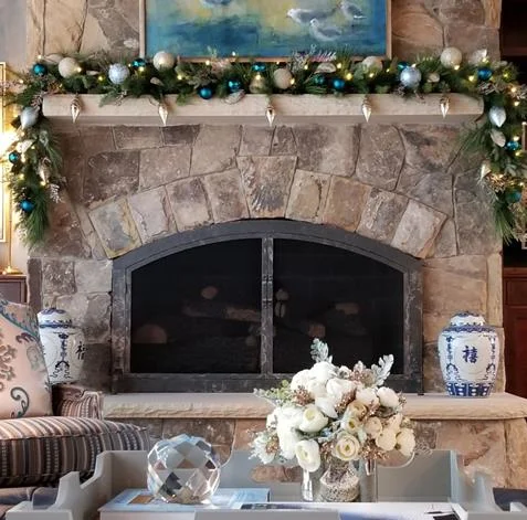 The fireplace in our client’s home soars to the ceiling. Look below to see how our photographer, Dustin Peck, captured it in full glory, prior to our decorations. I loved the garland and ornaments nestled in place.