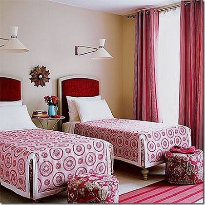 Bedroom with two single beds and red curtain on a large window