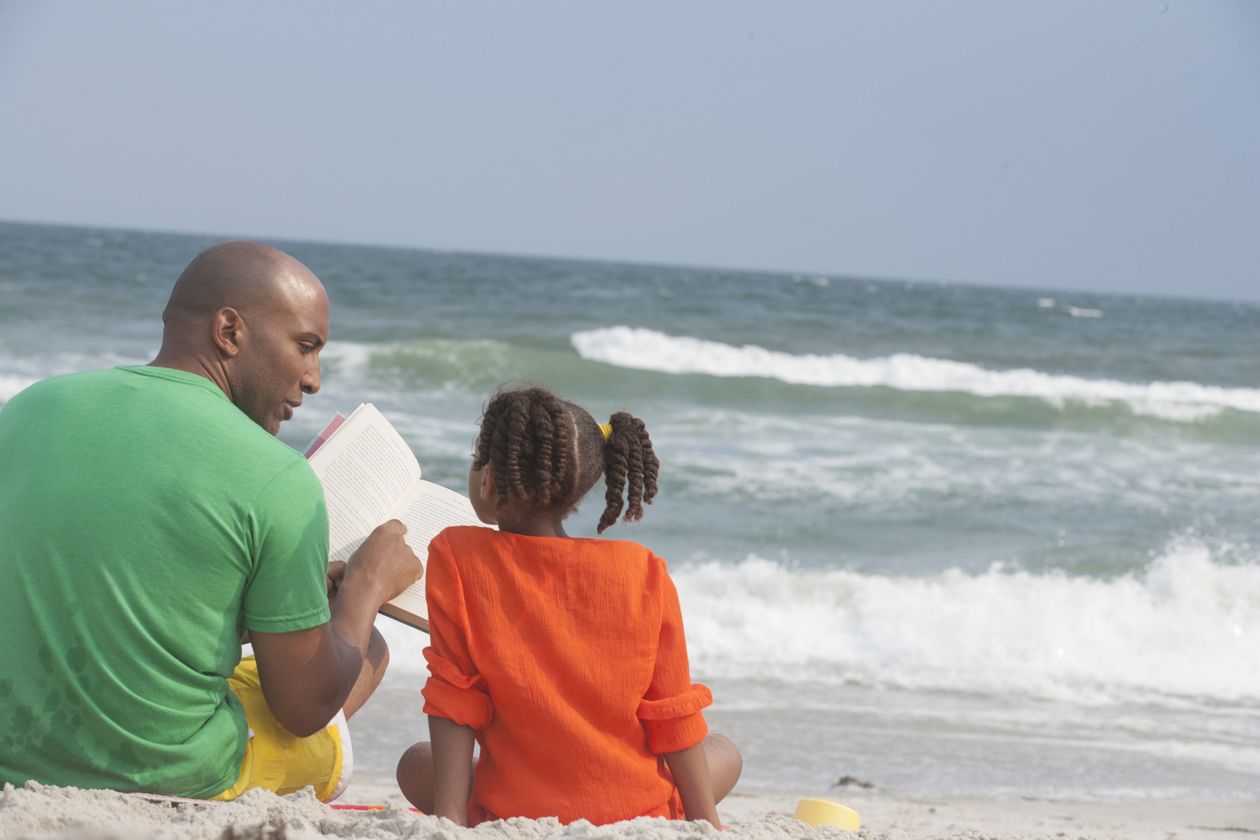 family-reading-at-the-beach-SBI-301041246.jpg