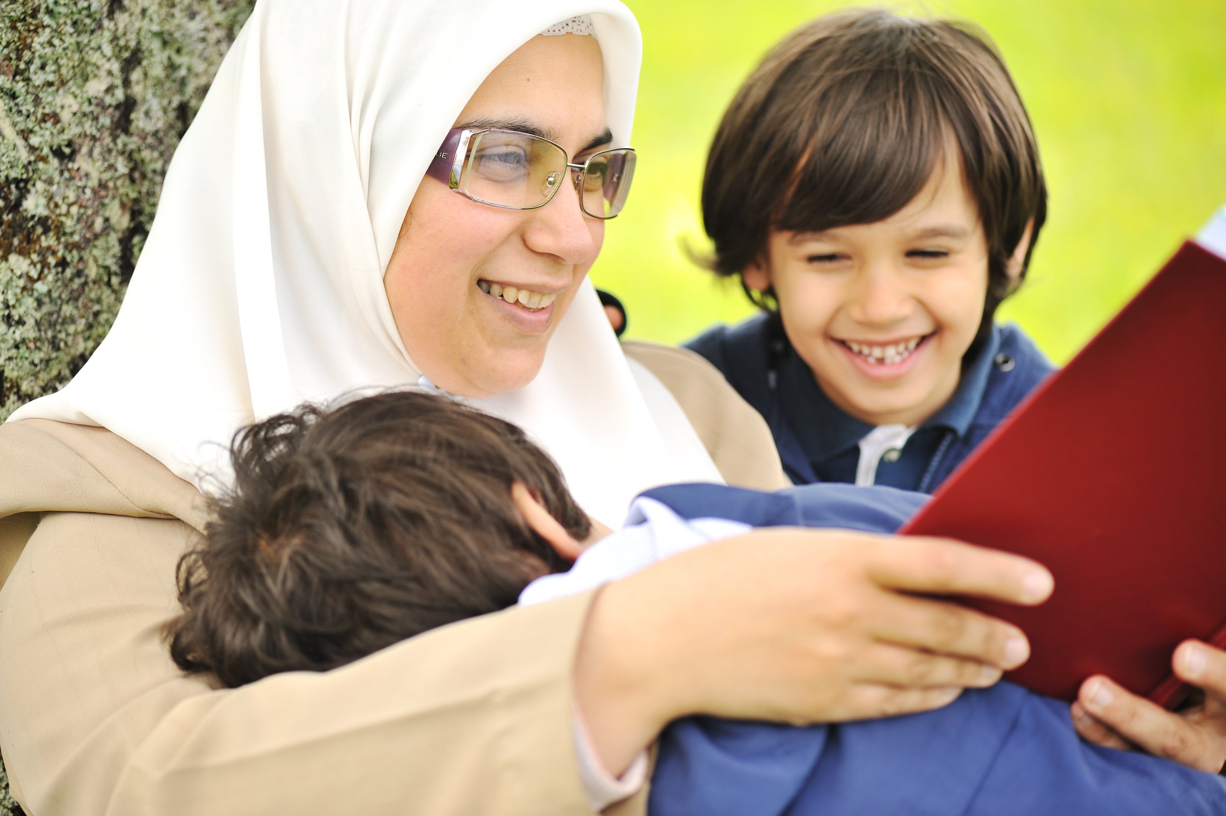 mother-muslim-and-her-son-in-the-nature-reading-together-SBI-300989092.jpg