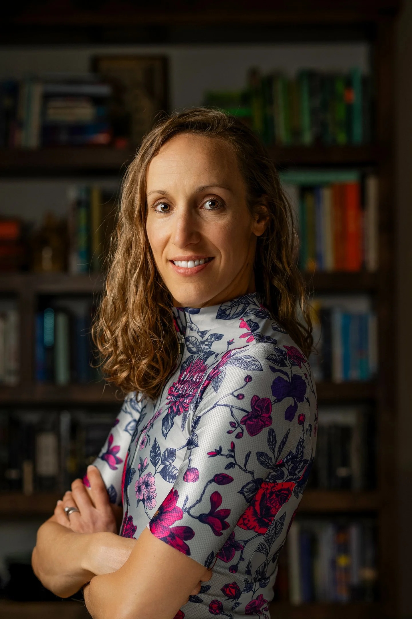 Person identified as Kelly Trom Nygren has shoulder length hair and is wearing a bike jersey.