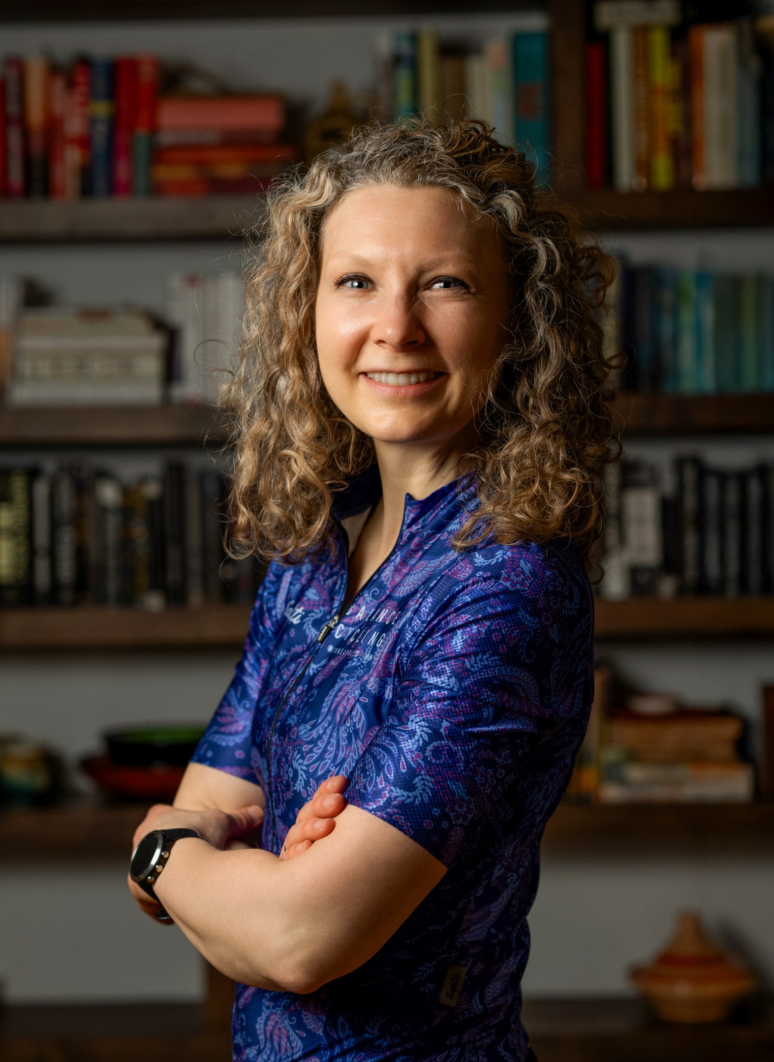 Person identified as Amber Quito has shoulder length hair and is wearing a bike jersey.