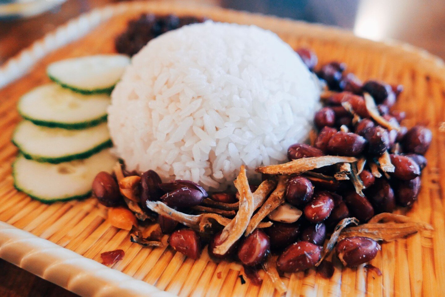 Our snack-sized Nasi Lemak Economical gives you coconut rice for rich carb-y goodness, ikan bilis for some umami crunch, slices of cucumber for a bit of healthy green, and a dollop of our special sambal for that spicy kick!