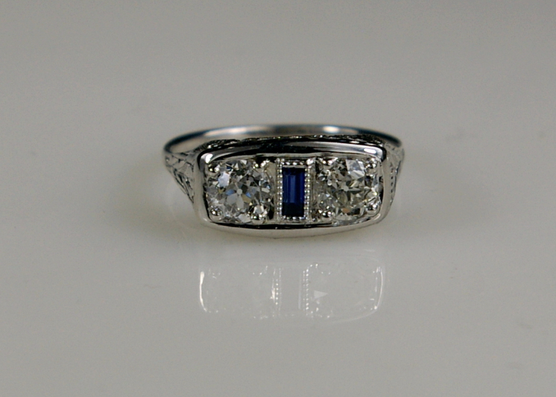 The same ring after restoration with a fine sapphire baguette set in the center