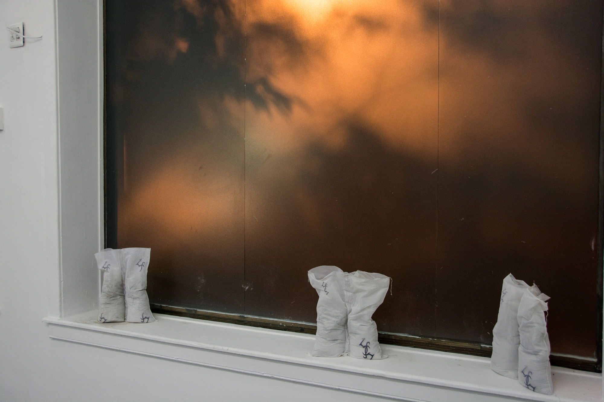 Laundered Fang (Window Ledge), 2016, Inkjet print on polyester voile bags, plastic bags, cement, (edition of 3)