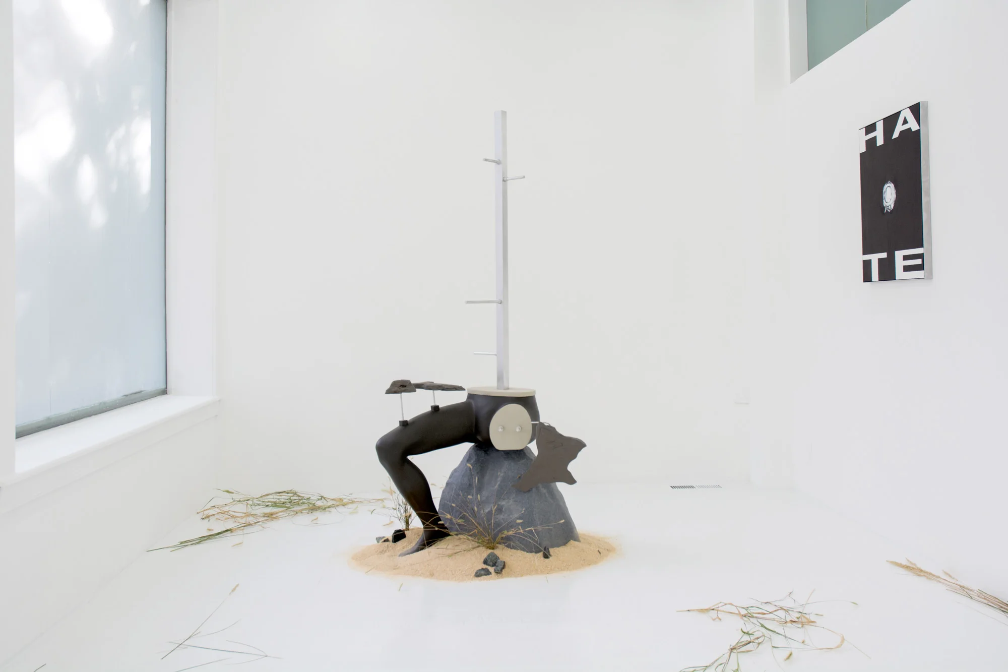 Against Use (Utility Landscape 1) , 2016, Mannequin, aluminum, plastic, enamel paint, foam, iron powder (left) Hate (Trinity 3) , 2016, Oil on canvas in aluminum frame (right)