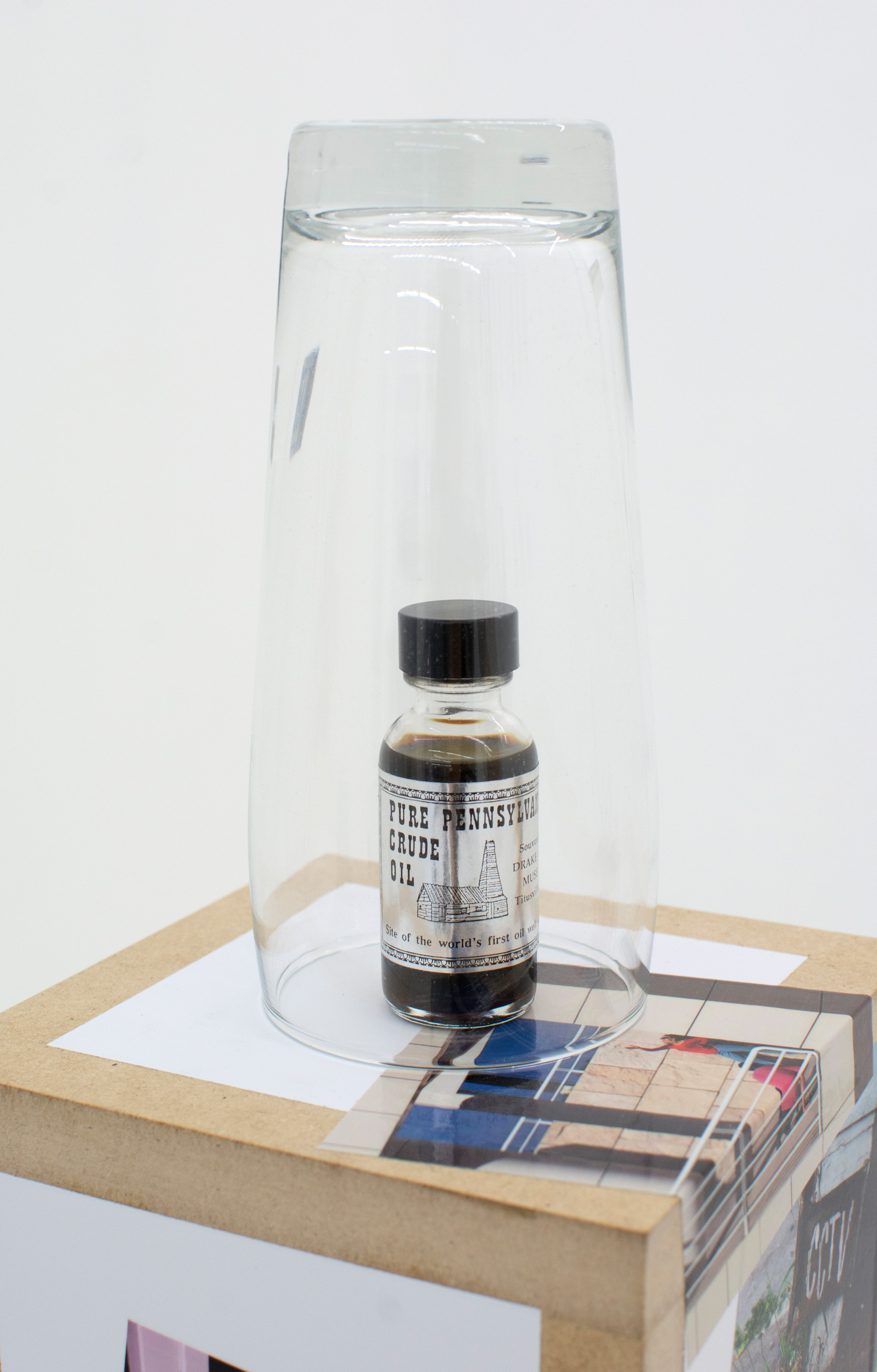 KEITH J. VARADI Declaration , 2016, Crude oil sample (Oil City, PA), pint glass, custom plinth, adhesive vinyls (detail)