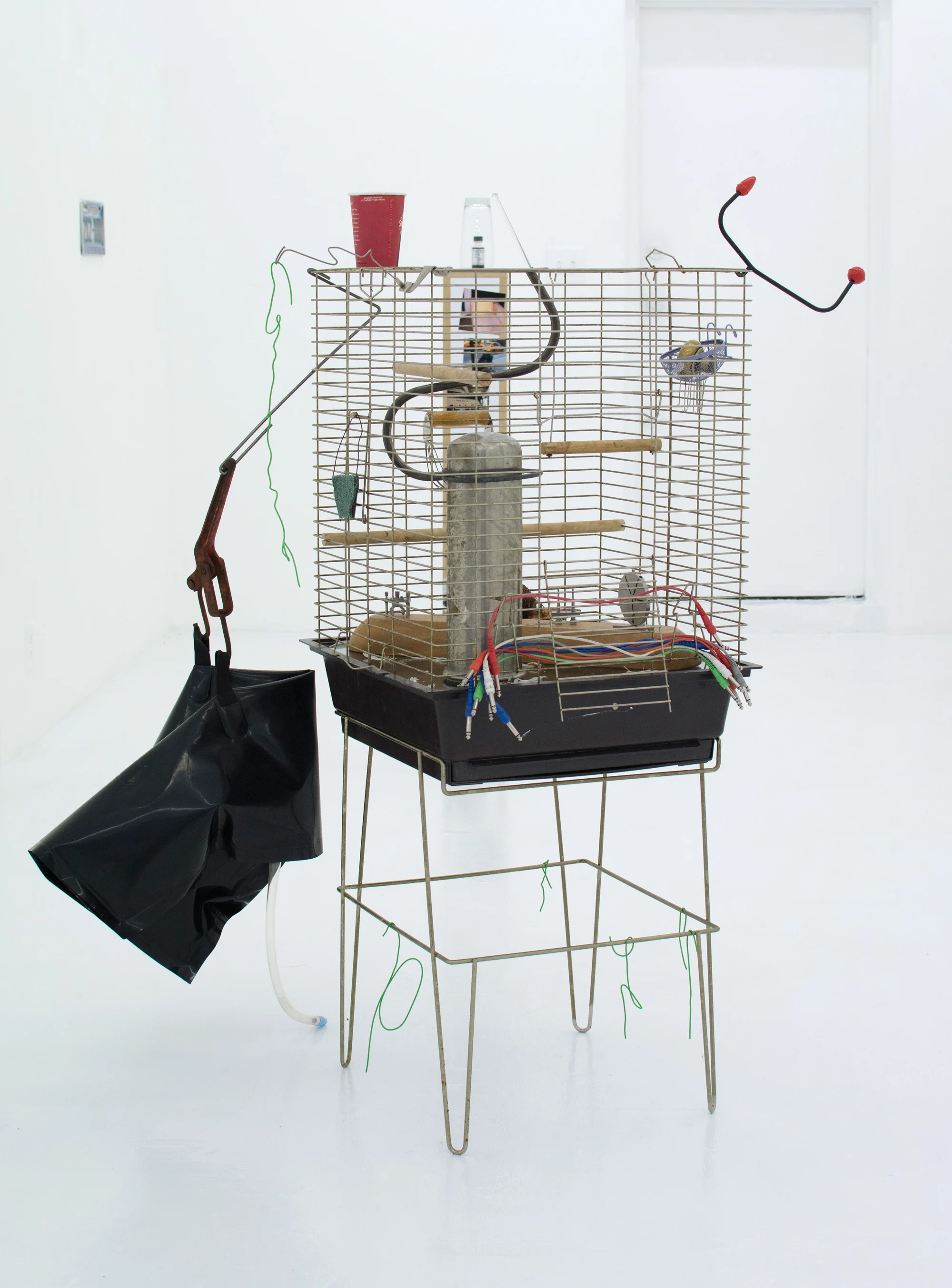 GEORGIA DICKIE Today was a rare day (Many Minutes of Fun) , 2016, Metal bird cage, glass, wood perches and swing, blood, auxiliary cables, found photographs, discarded canary feathers, doorknob, glass stirring rod, resurrection plant, coffee cup, PVC coated wire, various found objects