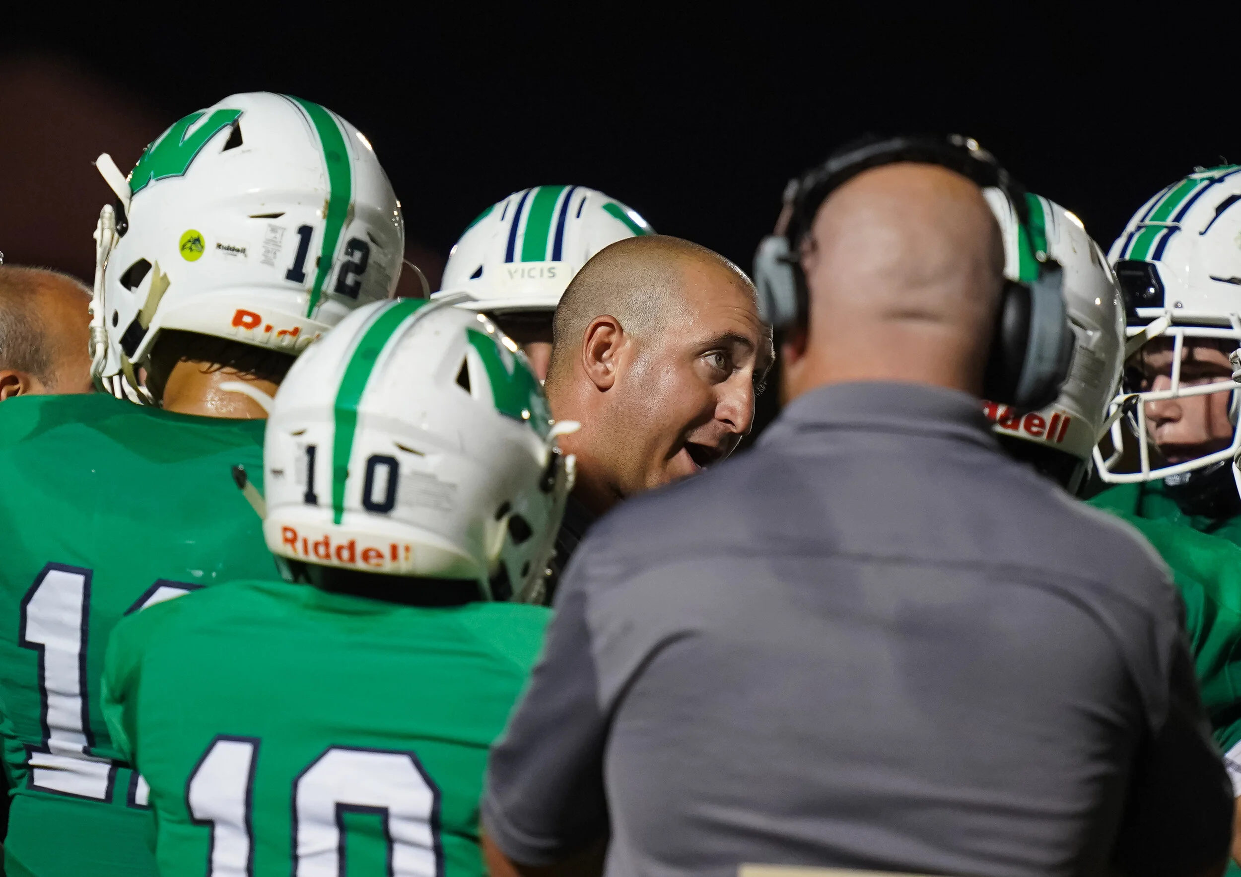 Weddington Head Coach Andy Capone talks to his offense.