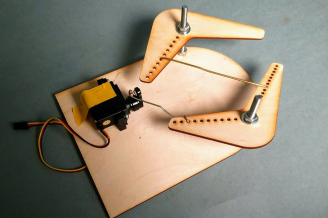 Another early design was a platform with two claws controlled by a single servo. The challenge with this design was that is was not space efficient because it required linkages or a gear system to move both claws.