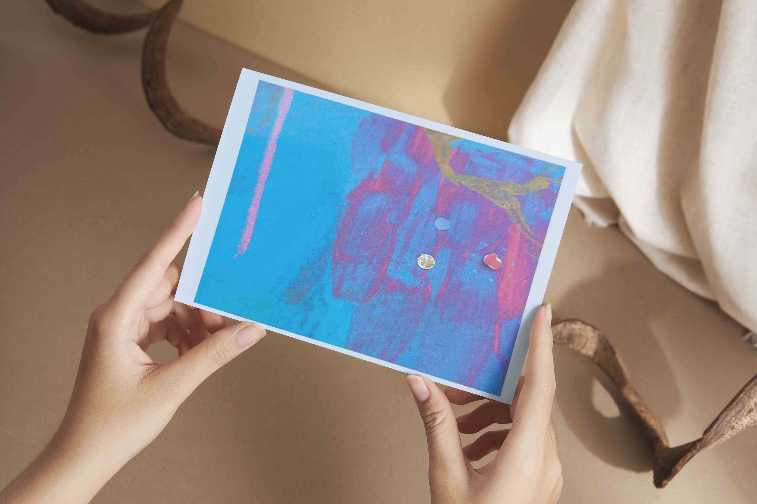 Hands holding Heather Moore Art Postcard.jpg