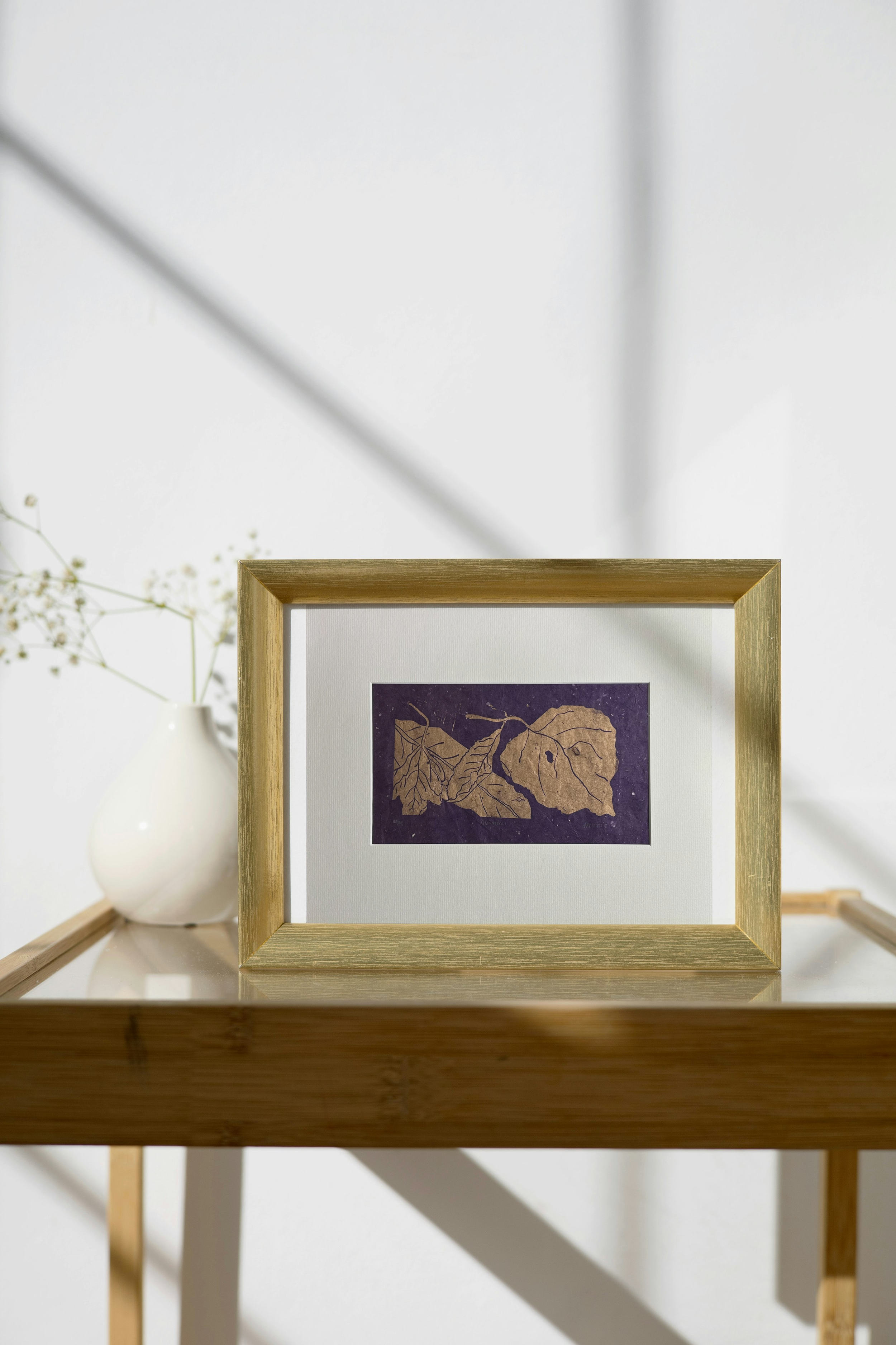 Autumn Leaves Metallic Linocut on Purple on Metal Frame on Side Table.png