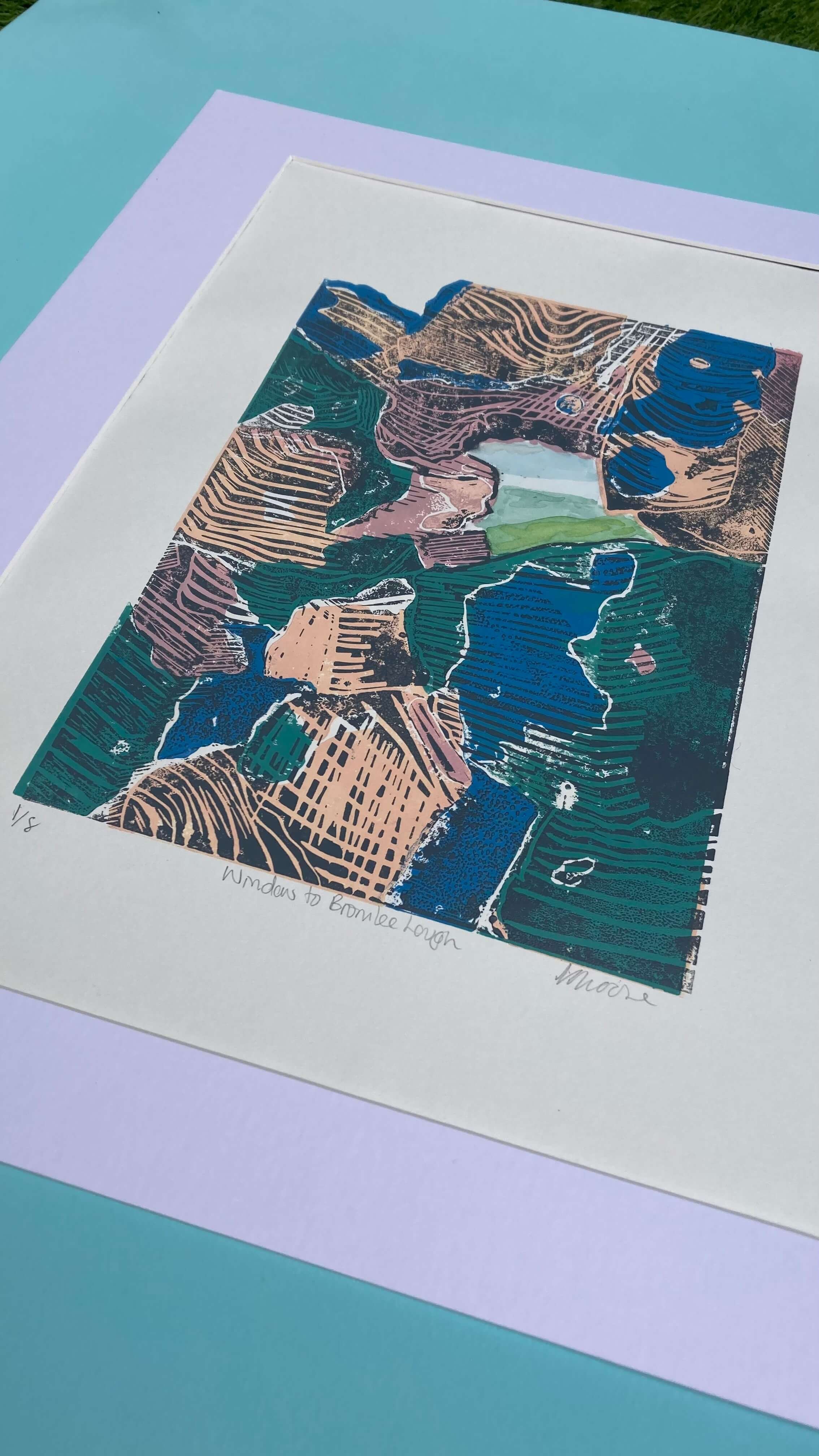 Artistic impression of a section of Hadrians wall I. blue, peach and green with a hole showing a lake with grey textures (Copy)