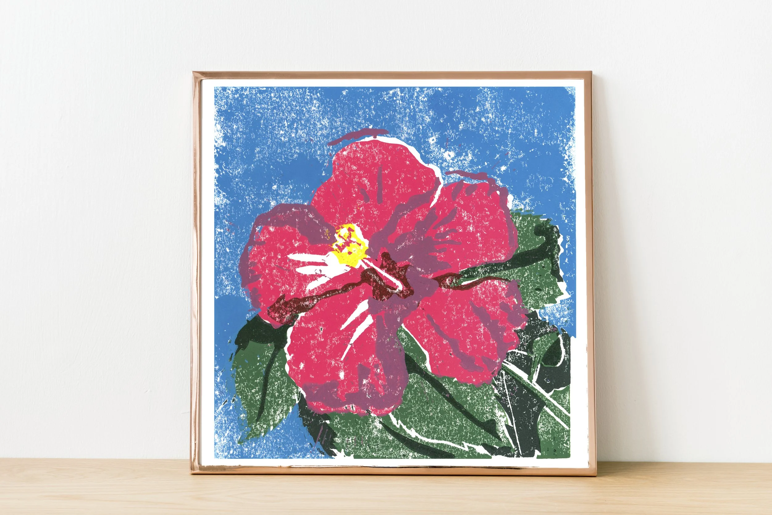 Pink Hibiscus in Metallic Frame against white wall and wooden shelf