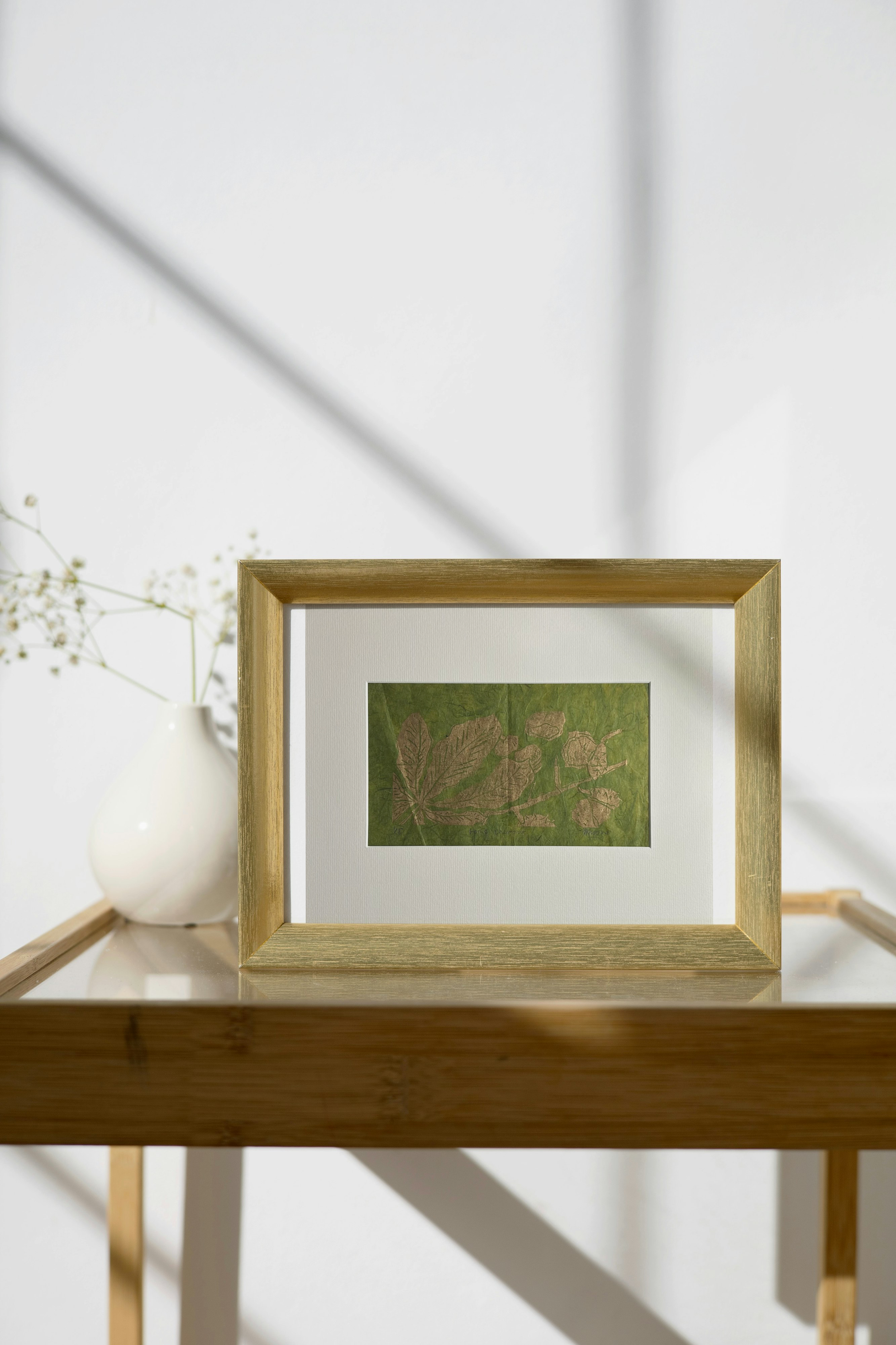 Horse Chestnut Metallic Linocut on Green on Metal Frame on Side Table.png