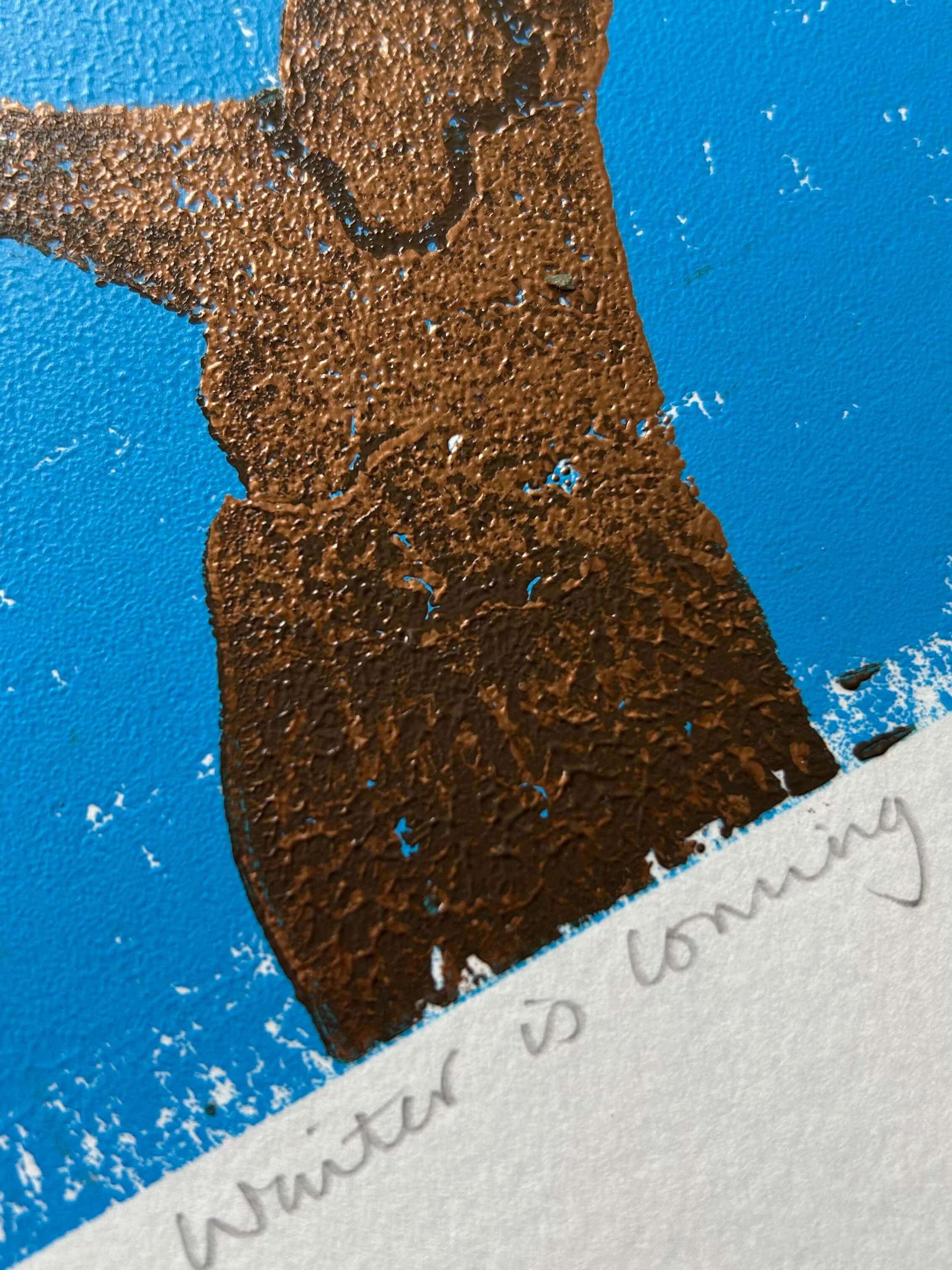 Naming detail of Limited edition linocut of the end of autumn when just a few leaves are left on the cherry tree - copper trunk against an ombre blue sky with leaves in green, yellow, orange and red