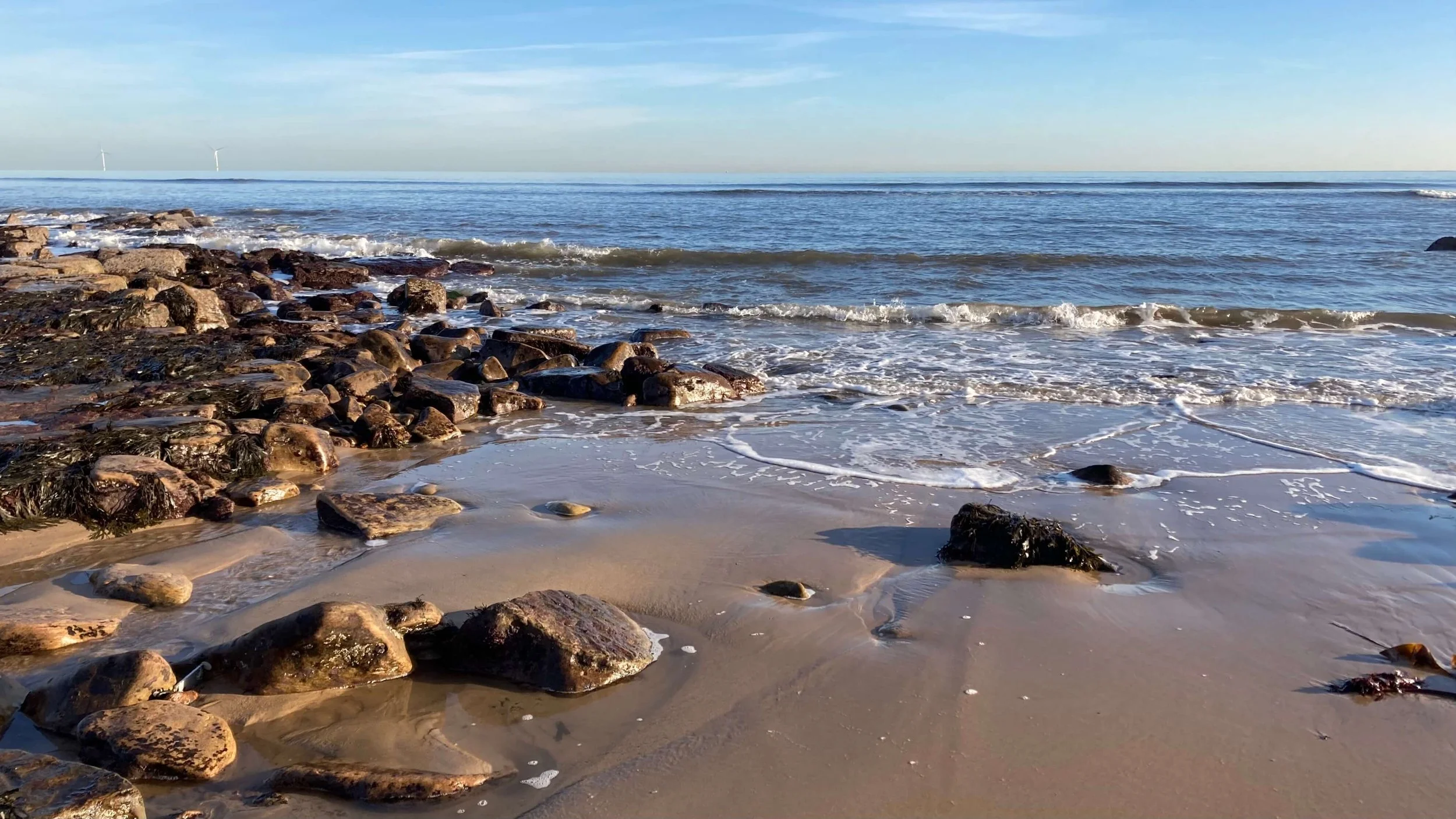 Rocky area of Whitley Bay Beach as the tide comes in