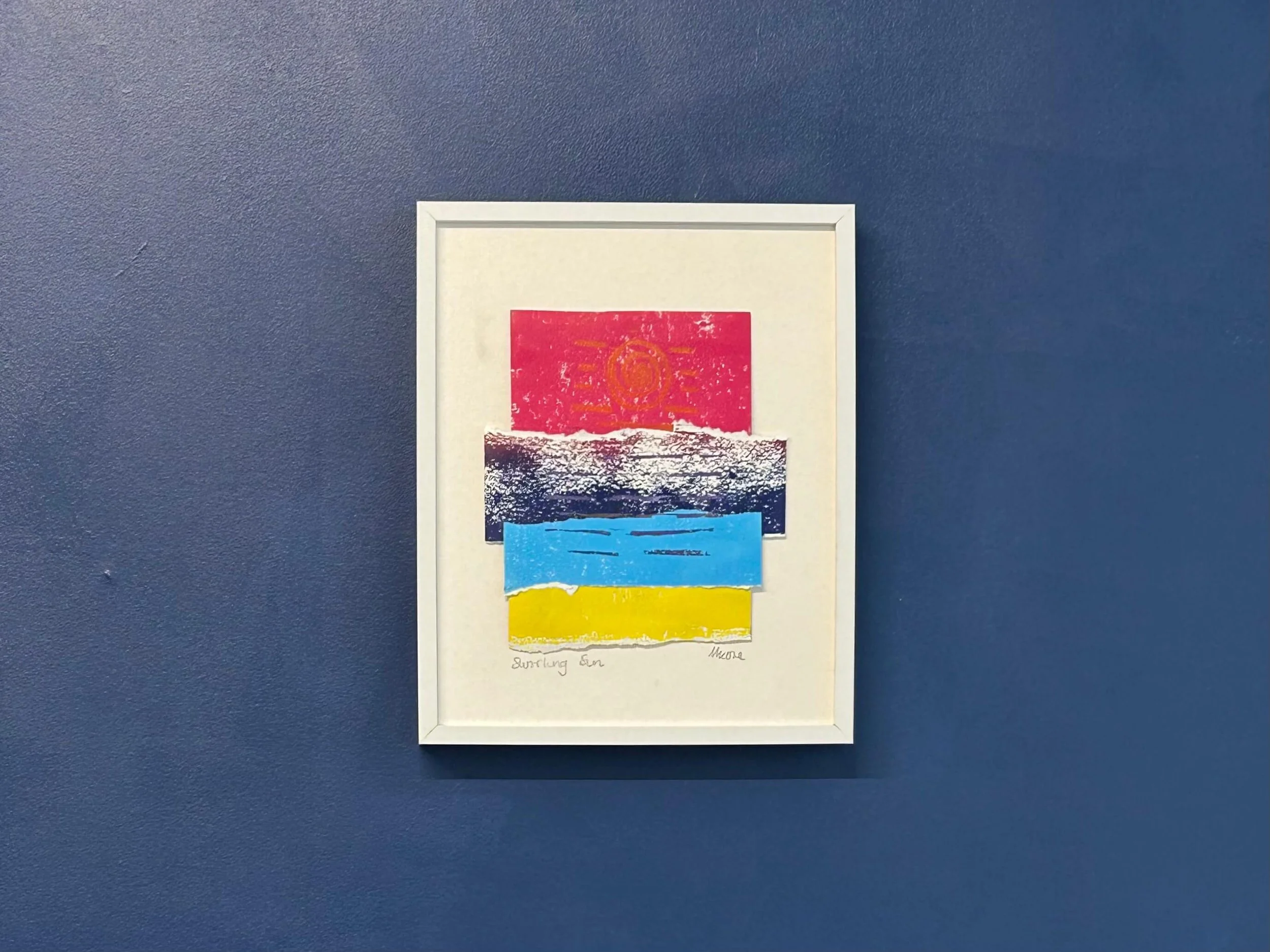 Pink sky abstract mixed media collage and print in white frame on navy wall