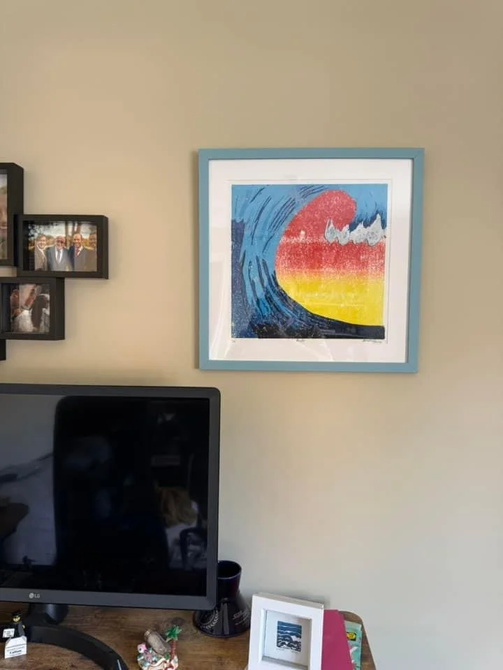 Client’s own photo of his office featuring ‘Rush’ original limited edition framed on the wall and mini framed wave open edition print on his desk.