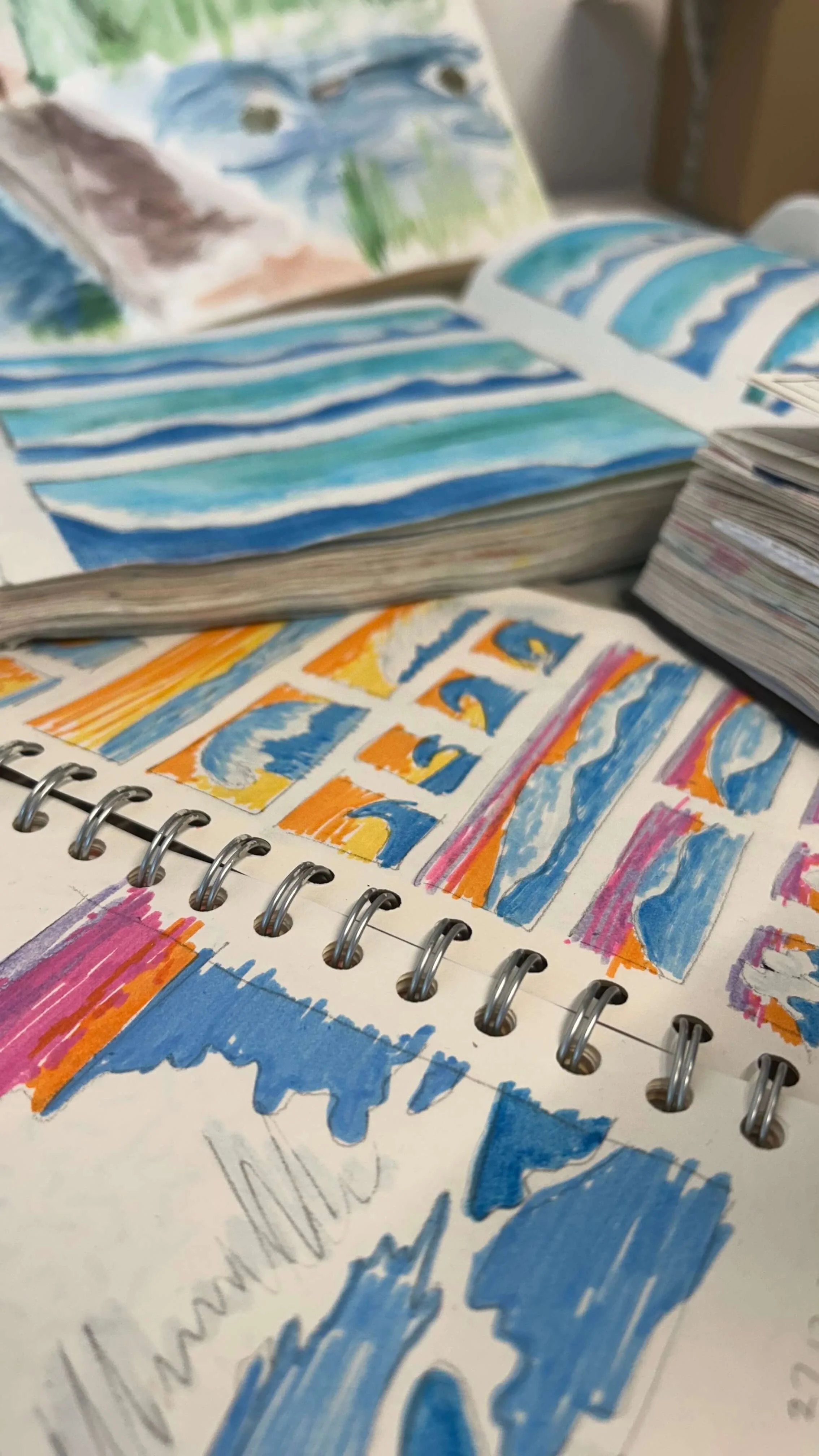 Pile of Artist Sketchbooks Open on a Table