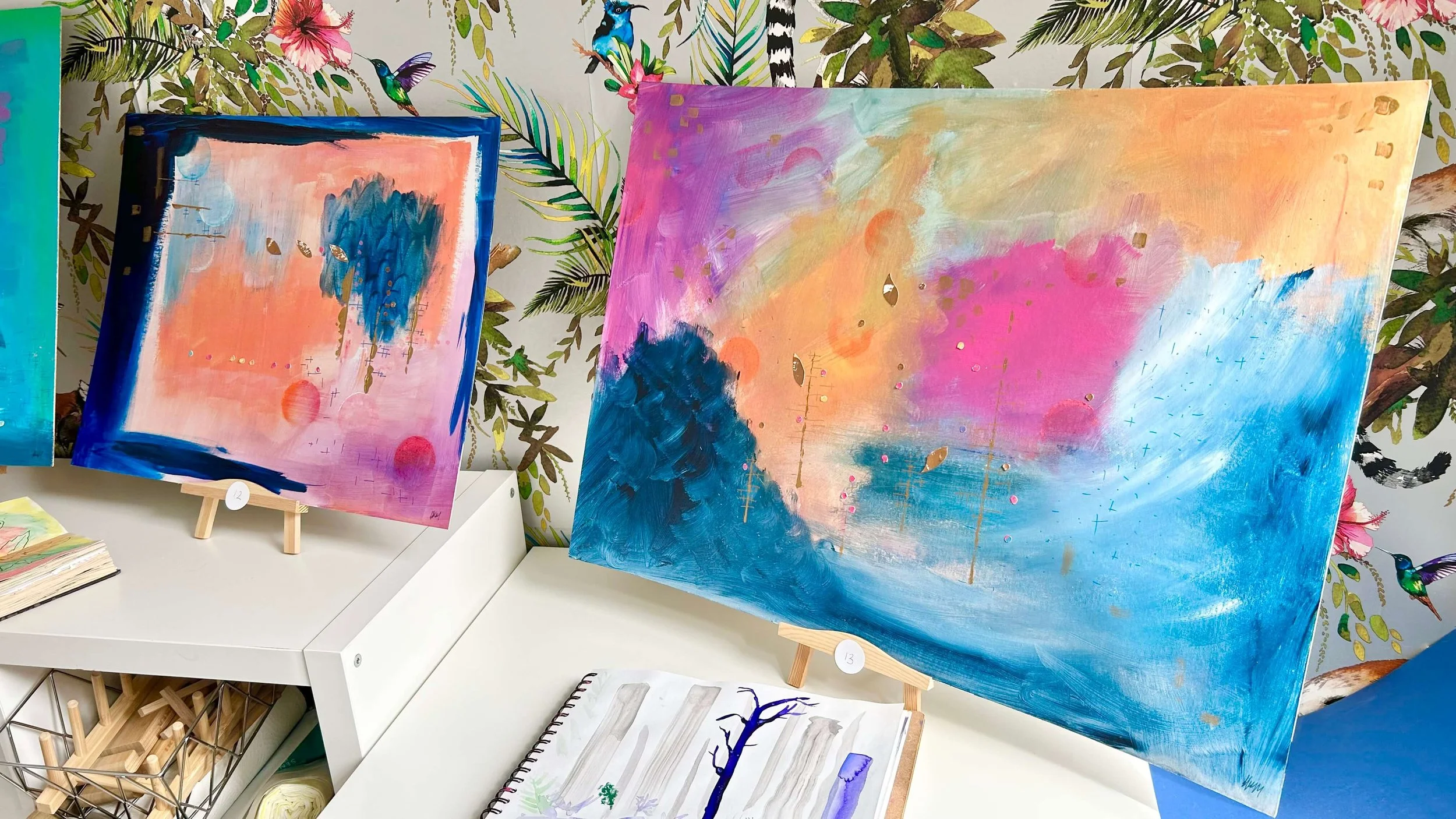 Two original mixed media artwork in vivd oranges, pinks, navy and gold staging on table top easels