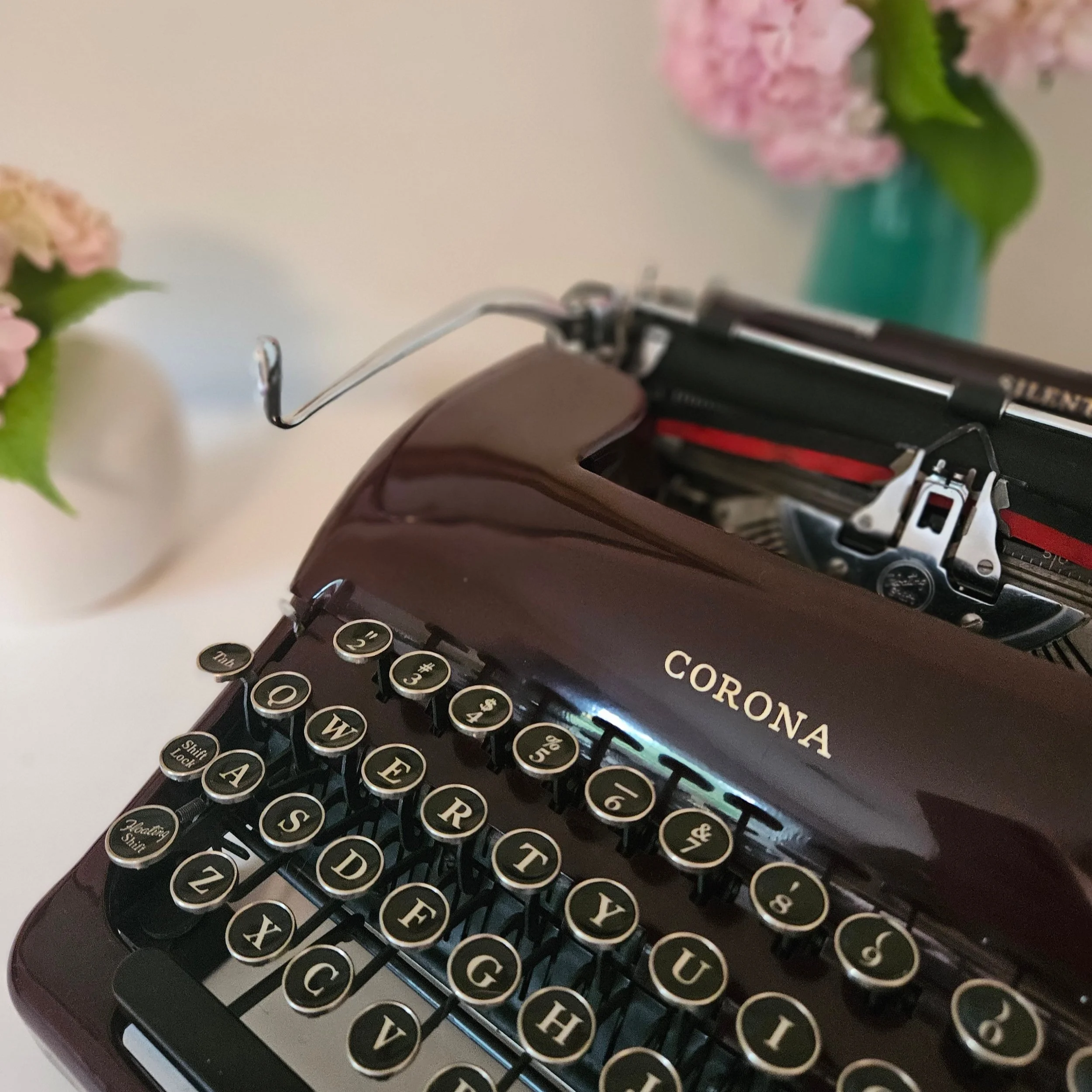 Restored Corona Silent typewriter in rare maroon, with pink hydrangeas.