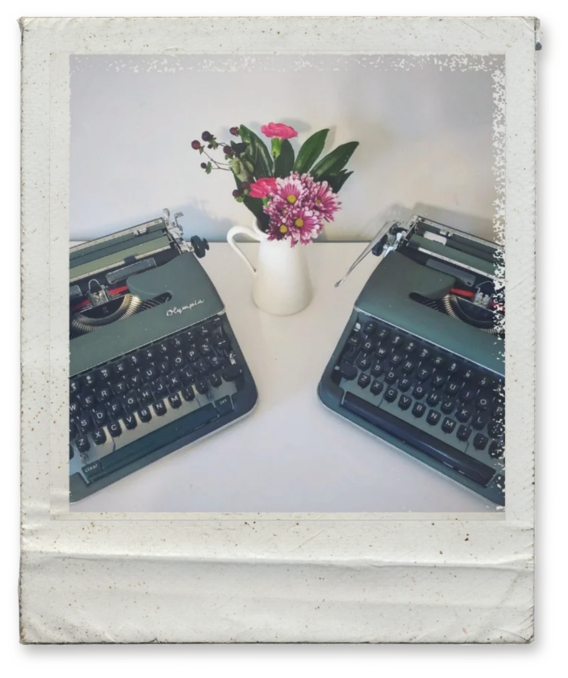 Two Olympia SM typewriters side by side, an SM3 and an SM4, both in green