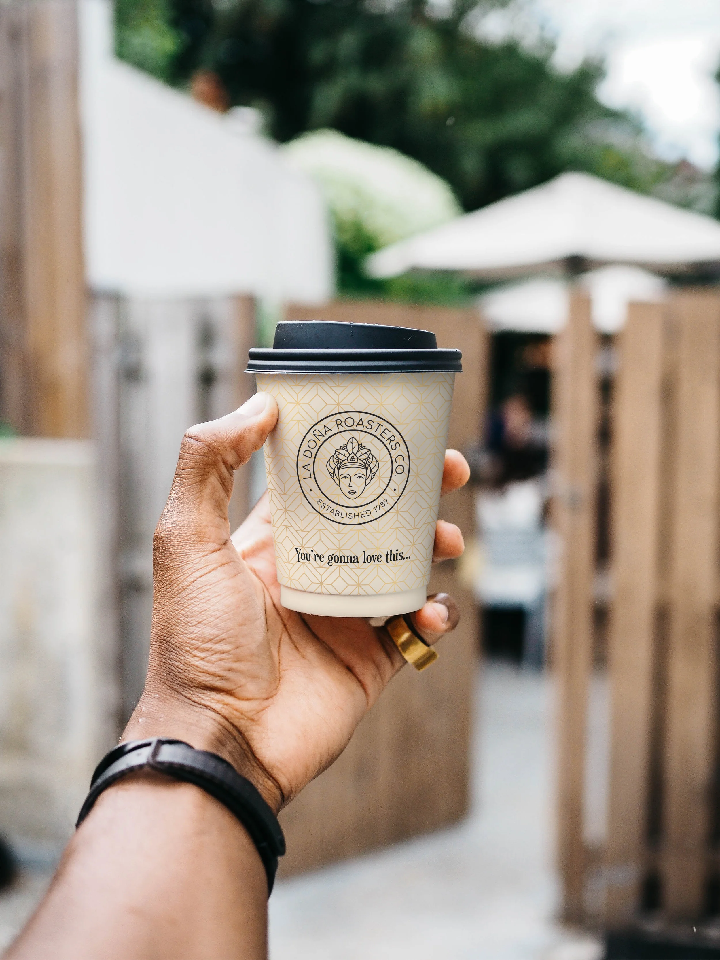 la dona coffee roasters co - Cup with Hand.jpg