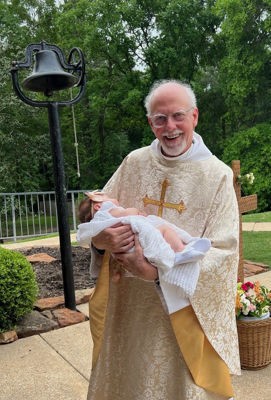 Fr. Jerald holds Catherine Grosch after her baptism