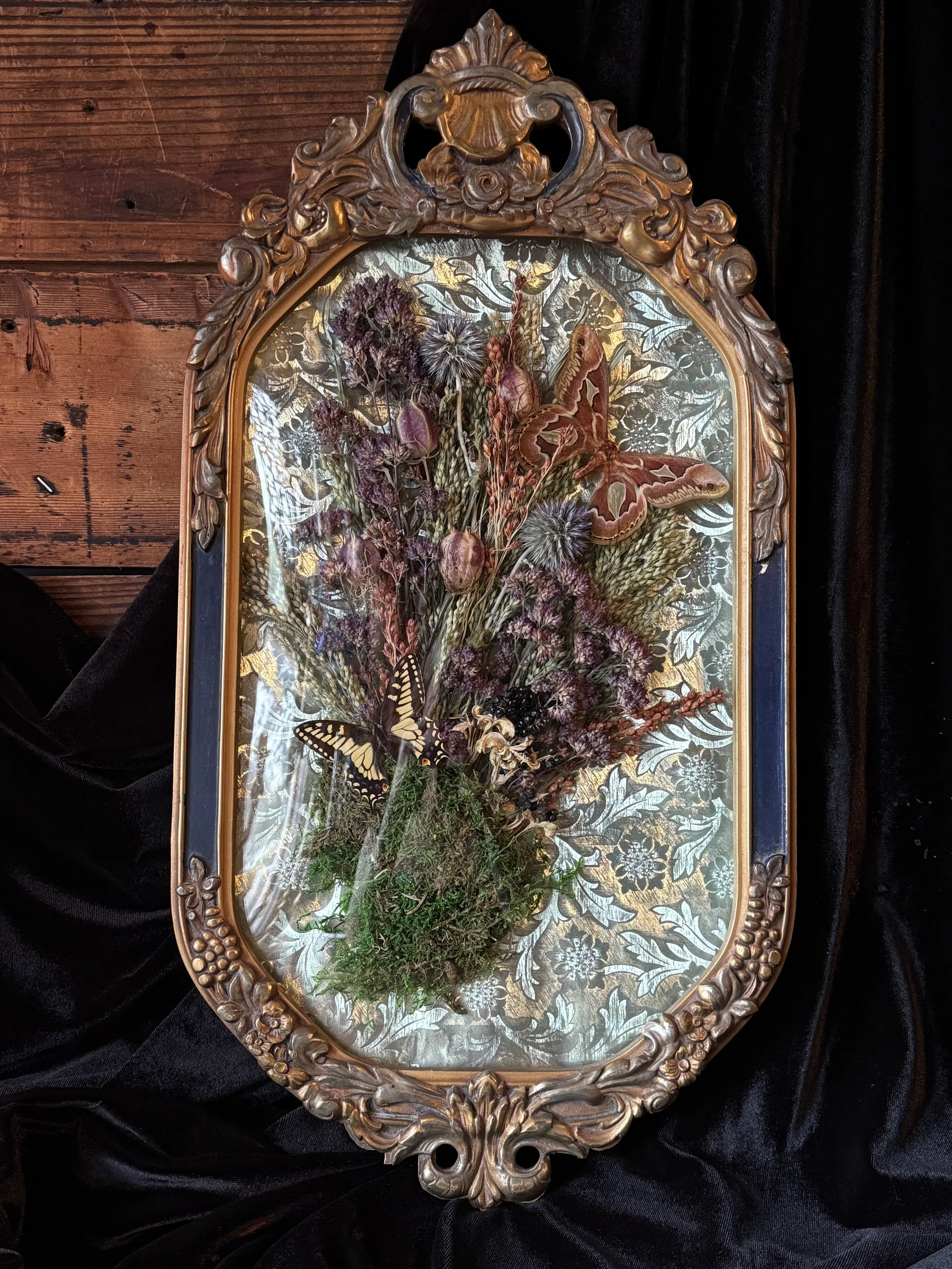 victorian style floral and butterfly wreath set in a vintage bubble glass frame