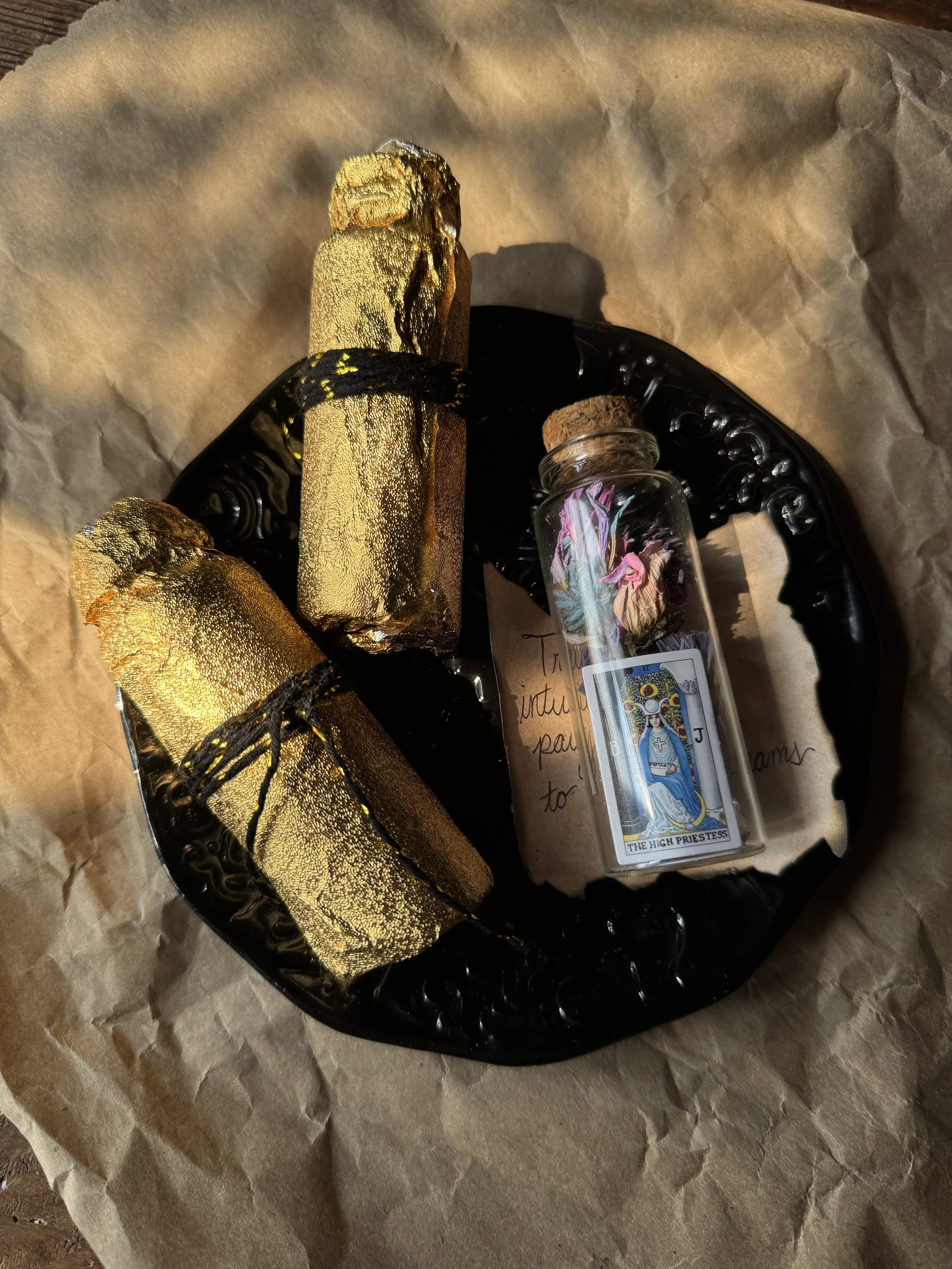 Tarot inspired mystery foil bottles wrapped in golden foil and containing dried flora nd crystals.