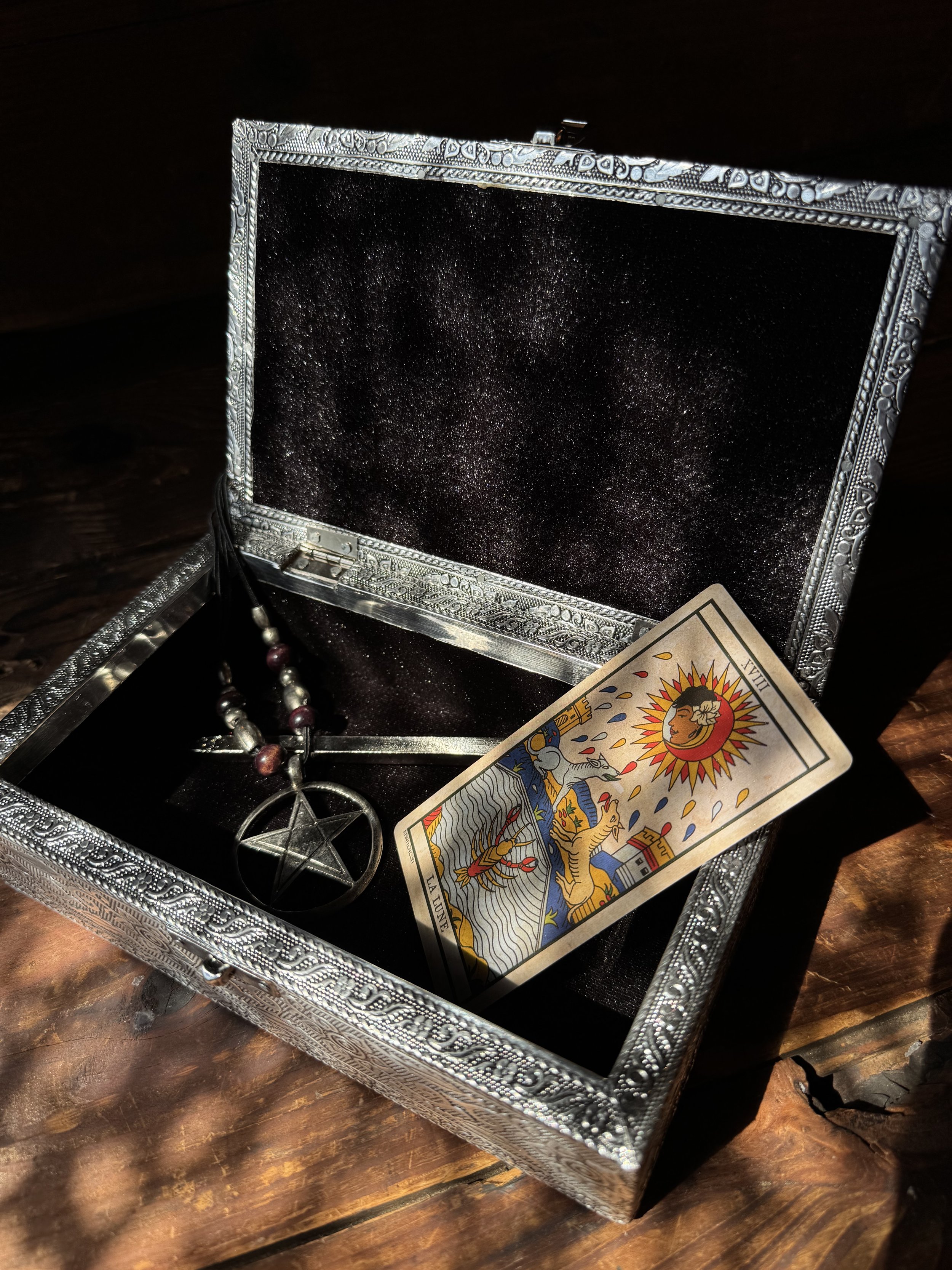 Silver tone skull embossed jewelry box lined with black velvet