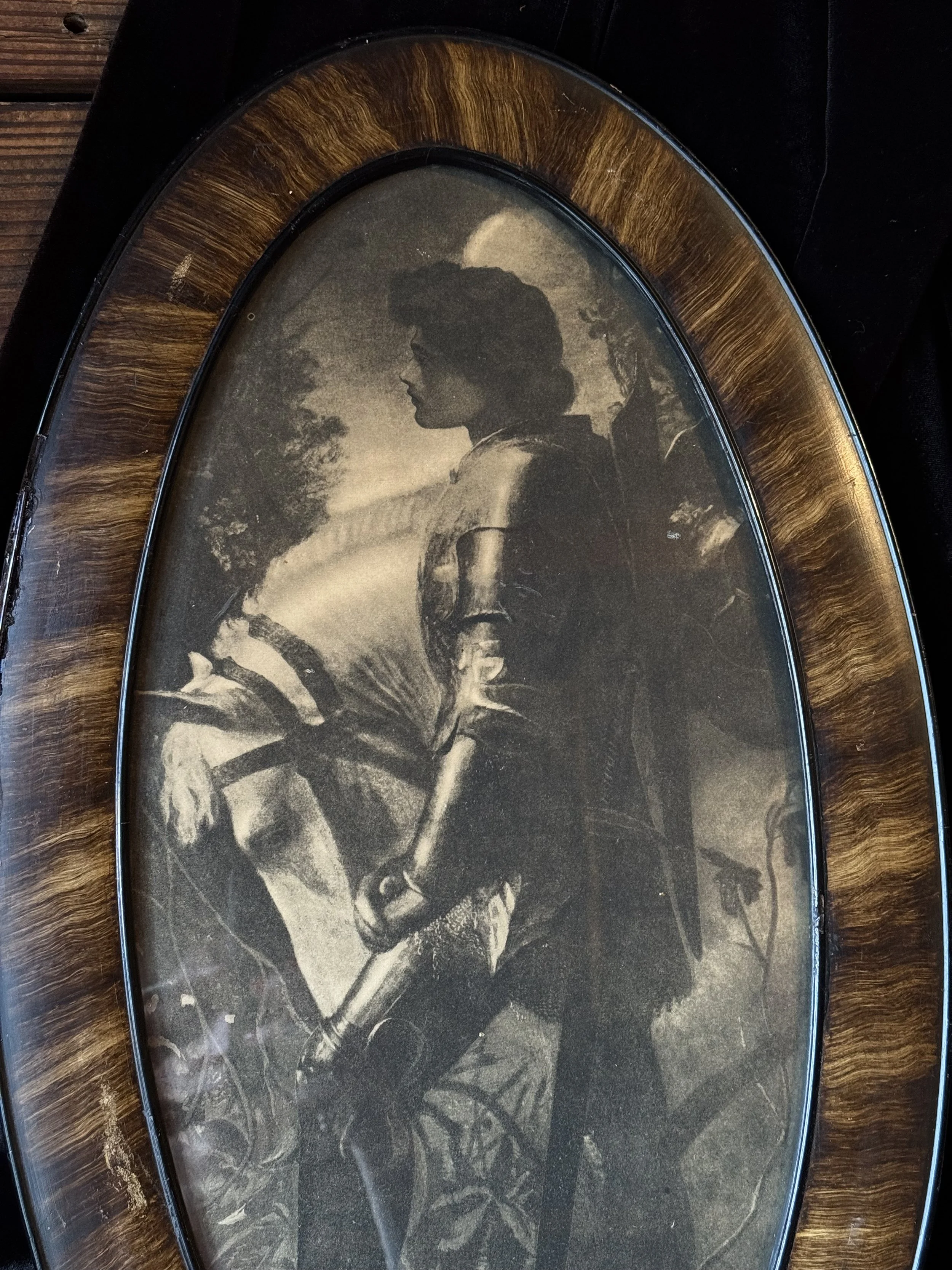 antique framed black and white print of joan of arc in an oval wood frame